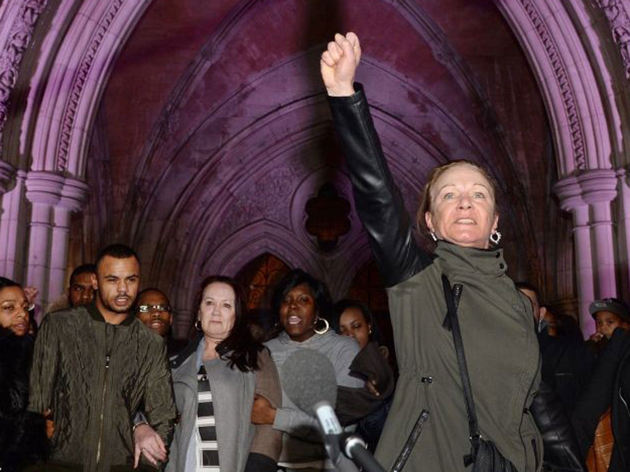 Mark Duggan's family, along with Duggan's aunt Carrol Duggan (R), make a statement outside the High Court in central London