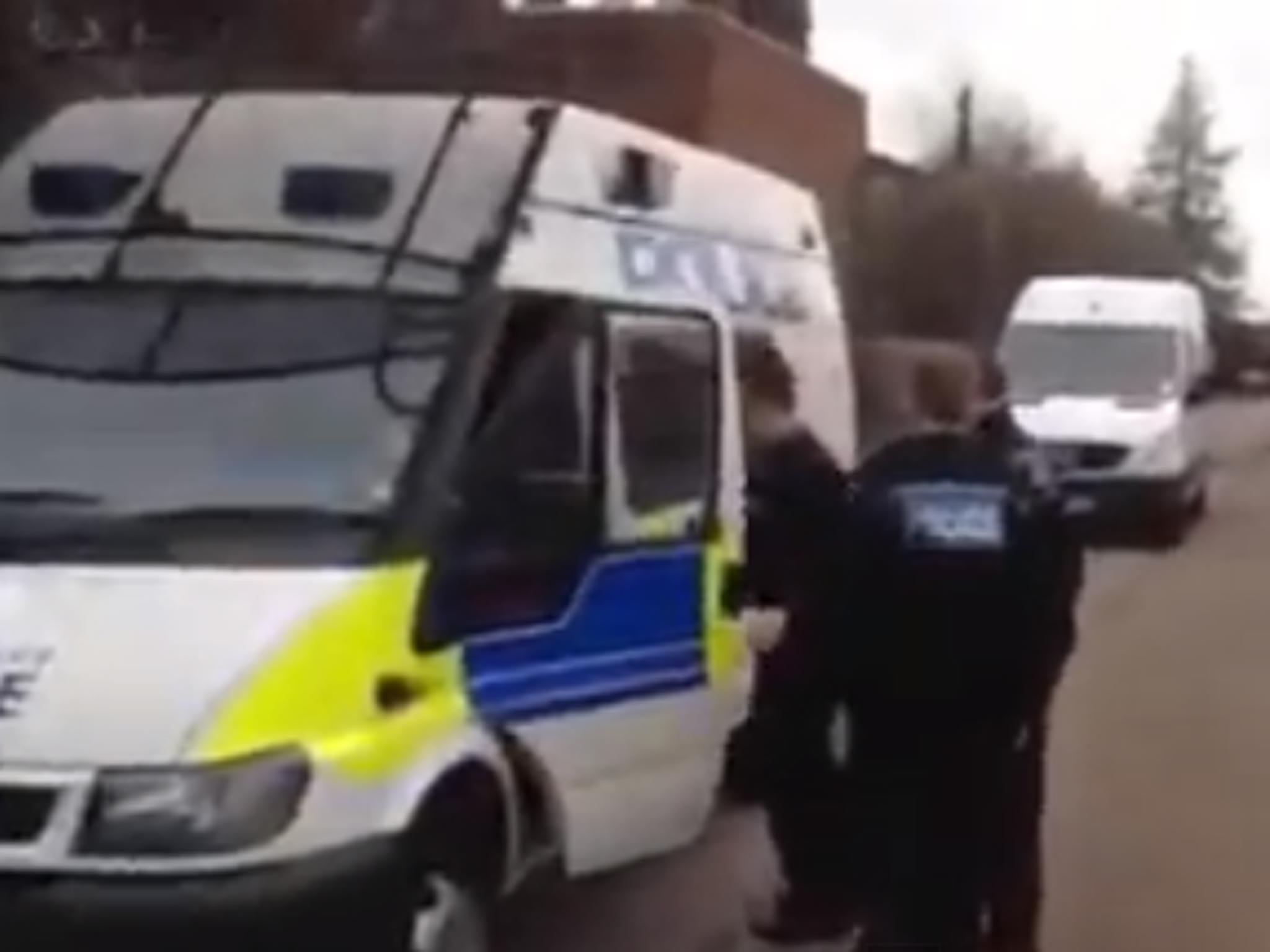 The PCSO officer is taken to the police car getting breathalysed