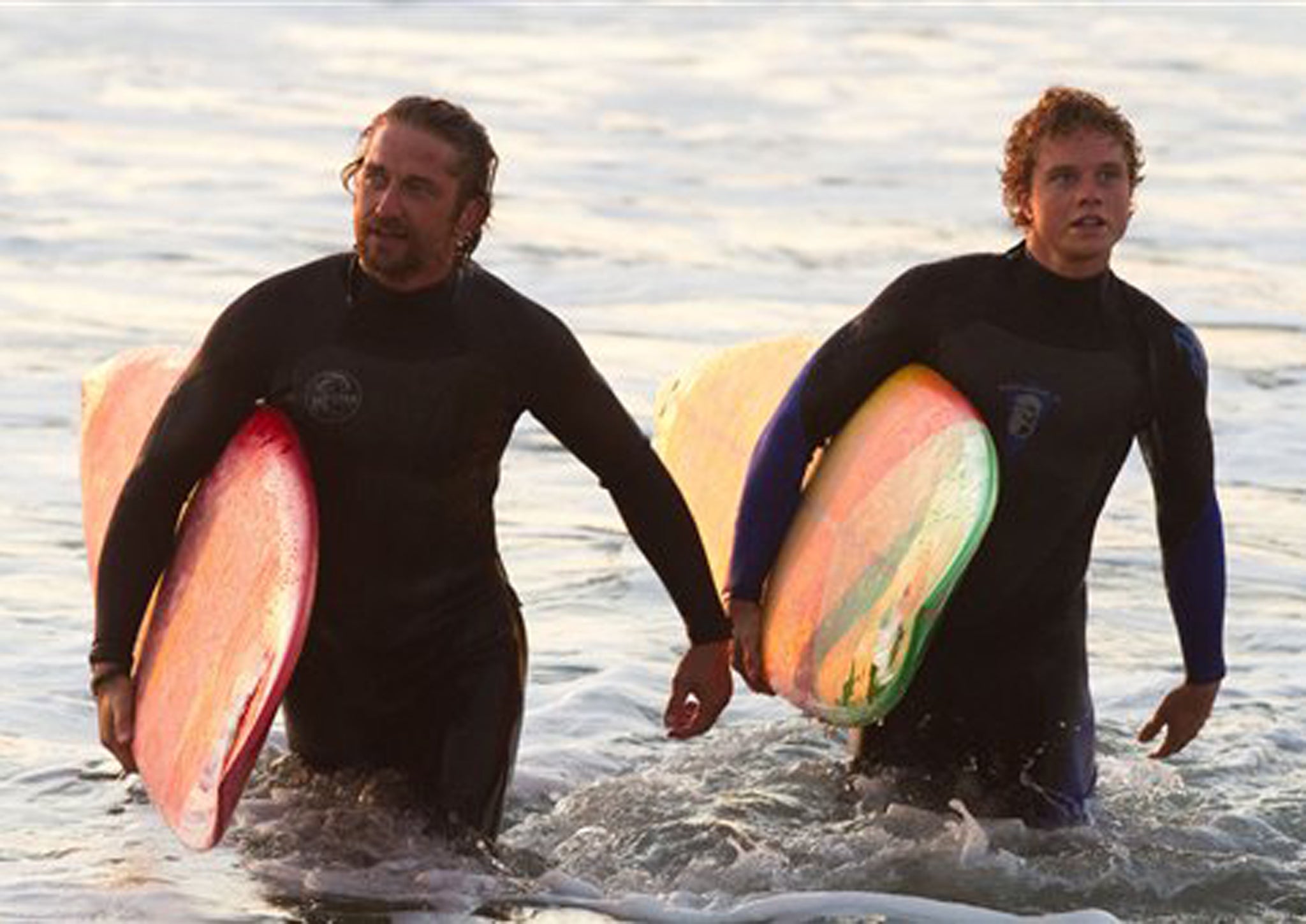 Gerard Butler, left, as Frosty Hesson in Chasing Mavericks, with Jonny Weston as Jay Moriarity