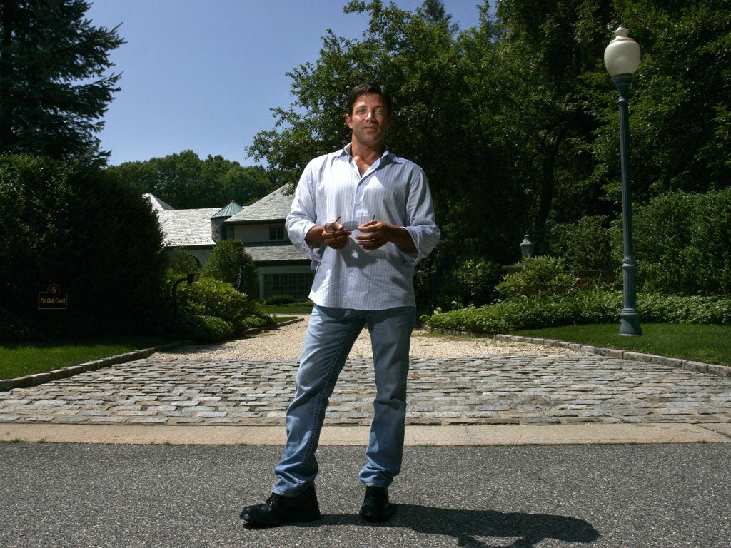 Jordan Belfort stands outside his former home