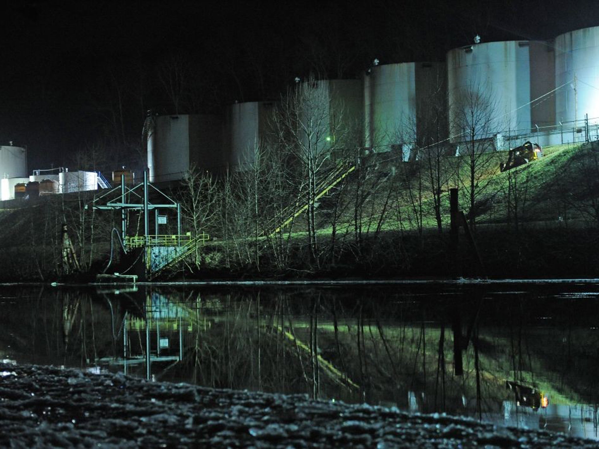 Crews clean up a chemical spill along the Elk River in Charleston, West Virginia