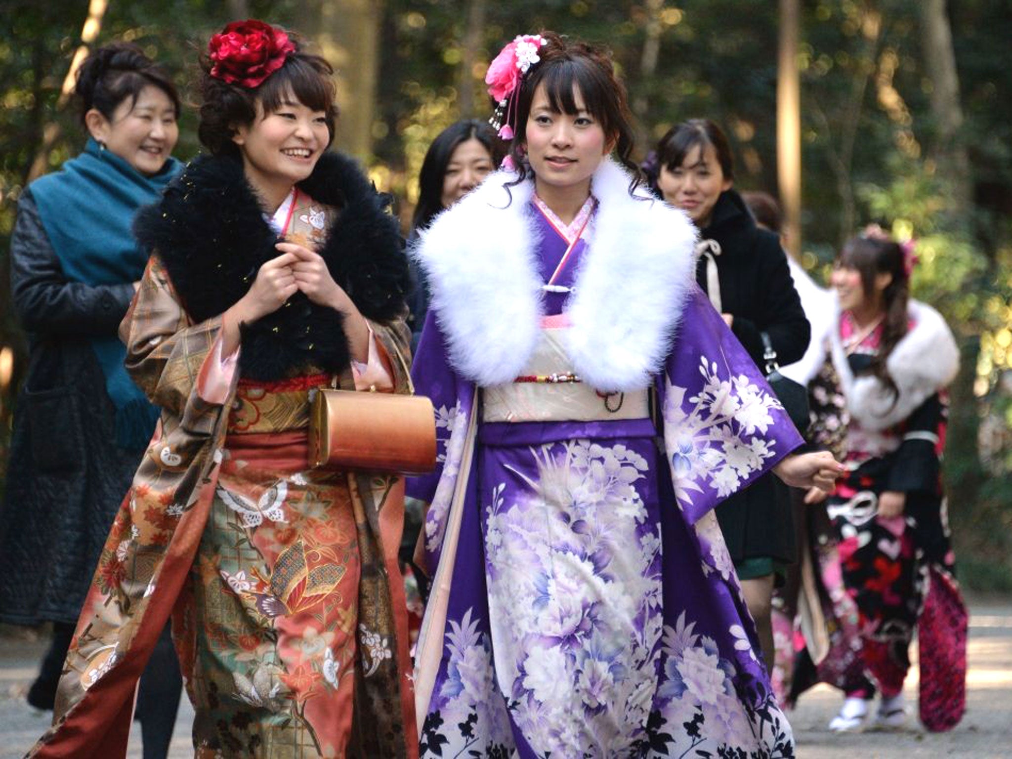 Female tour guides dressed in traditional kimonos visit Tokyo's Meiji Shrine to attend a purification ceremony with a Shinto priest to celebrate Japan's Coming of Age Day. The ceremonies are held at local and prefectural offices, as well as after-parties