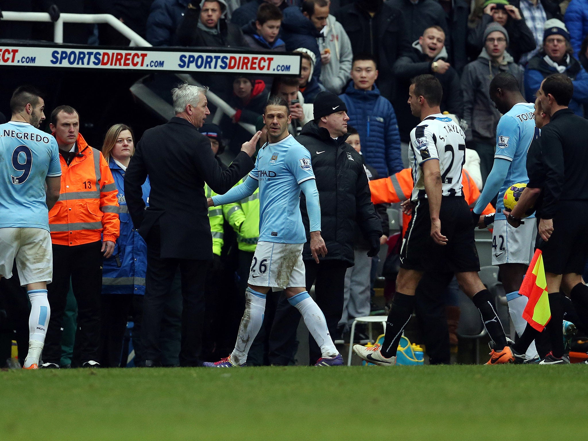 Newcastle United manager Alan Pardew (2-L) gestures towards Referee Mike Jones (2-R) as they leave the pitch at half time