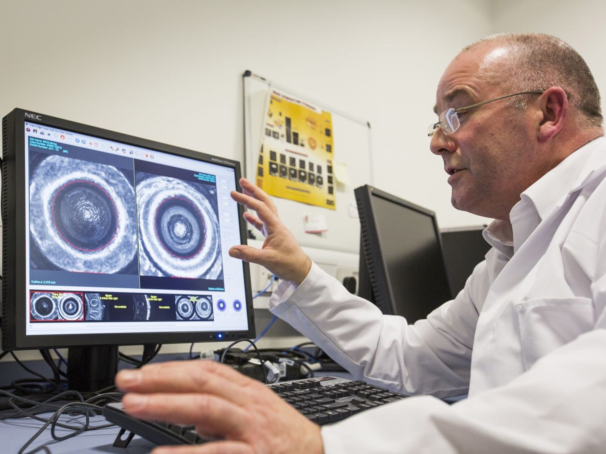 Tony Gallagher, a ballistics expert, showing extreme close-ups of spent cartridges on a computer screen in the lab at the National Ballistics Intelligence Service in Birmingham