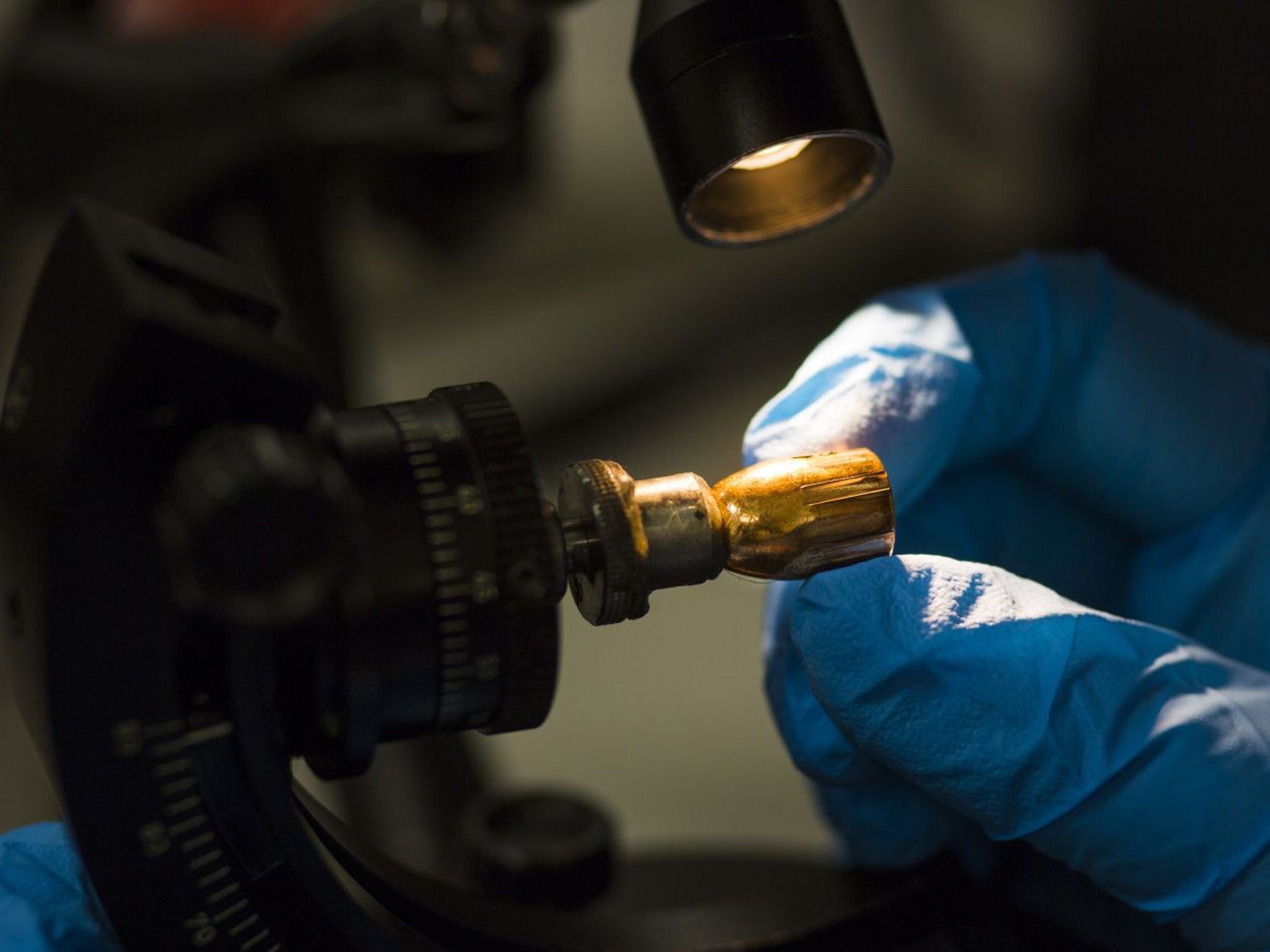 A fired cartridge under the microscope in the lab at the National Ballistics Intelligence Service in Birmingham. Firing marks are visible on the bullet