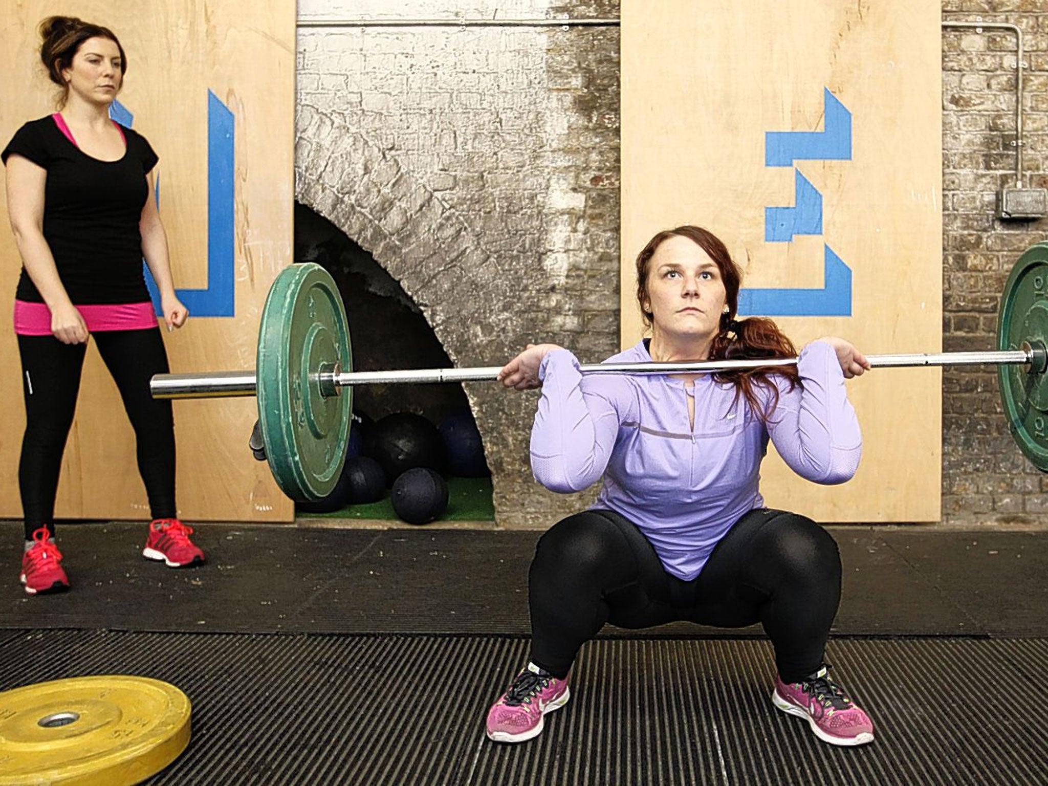Worth the weight: Alice Klein (wearing black and pink) and experienced CrossFitter Lauren Dagger