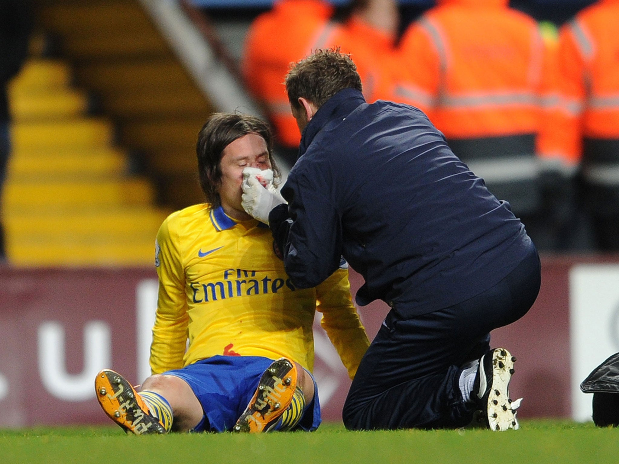 Tomas Rosicky receives treatment after catching a stray elbow off Aston Villa striker Gabriel Agbonlahor during Arsenal's 2-1 victory