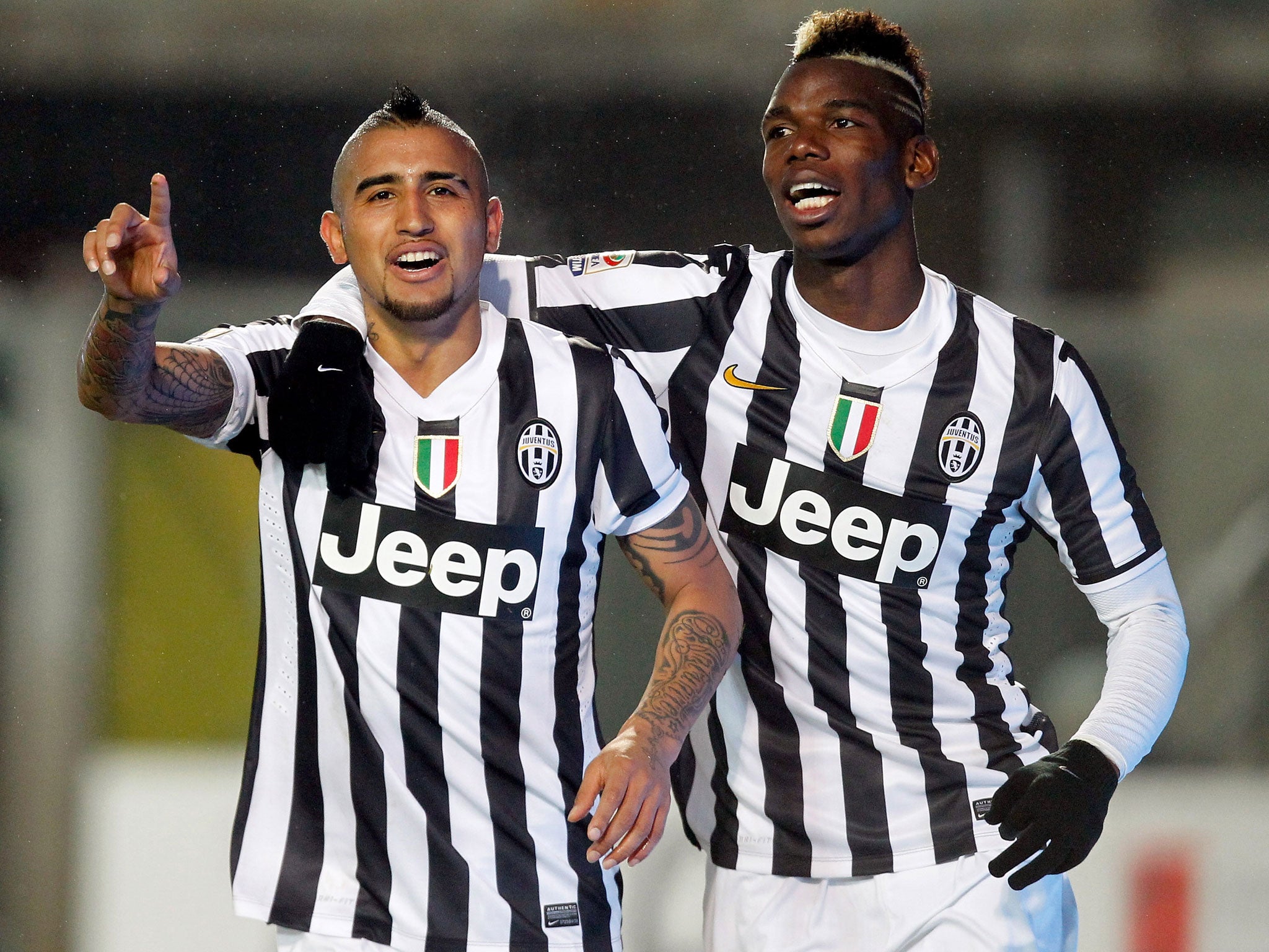 Arturo Vidal (L) and Paul Pogba of Juventus