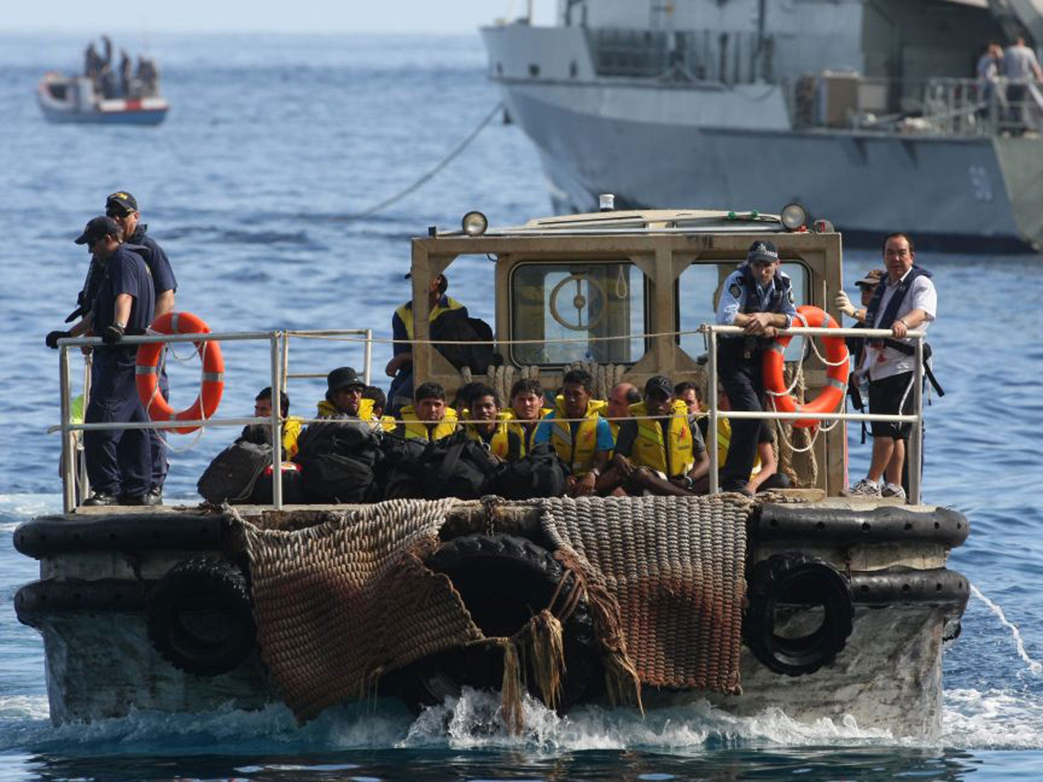 A barge carries asylum-seekers bound for detention centres on Christmas Island after their boat was intercepted