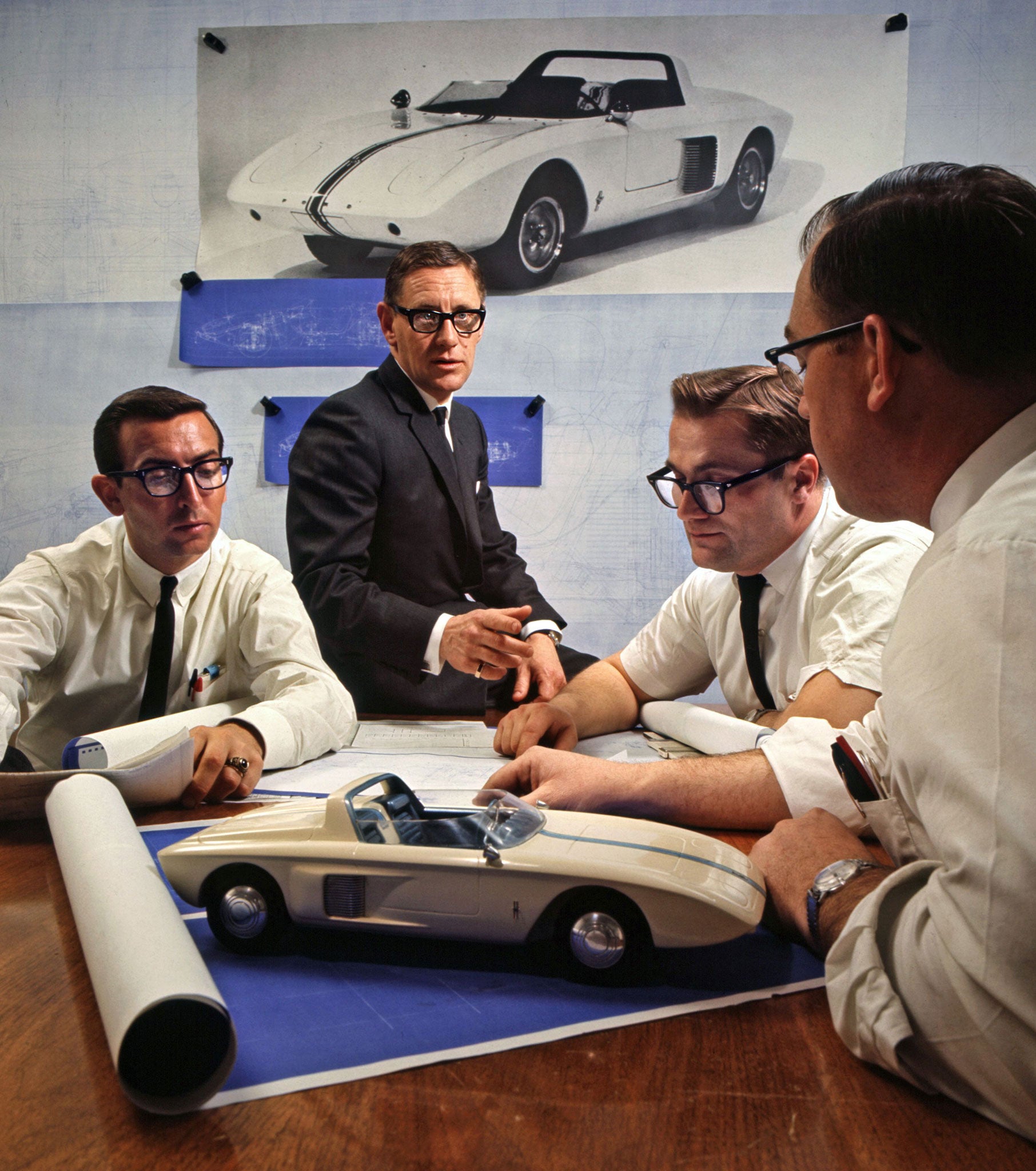 Executive Engineer Roy Lunn (centre) and assistants study the Ford Mustang 1 Model, which they first designed in 1962
