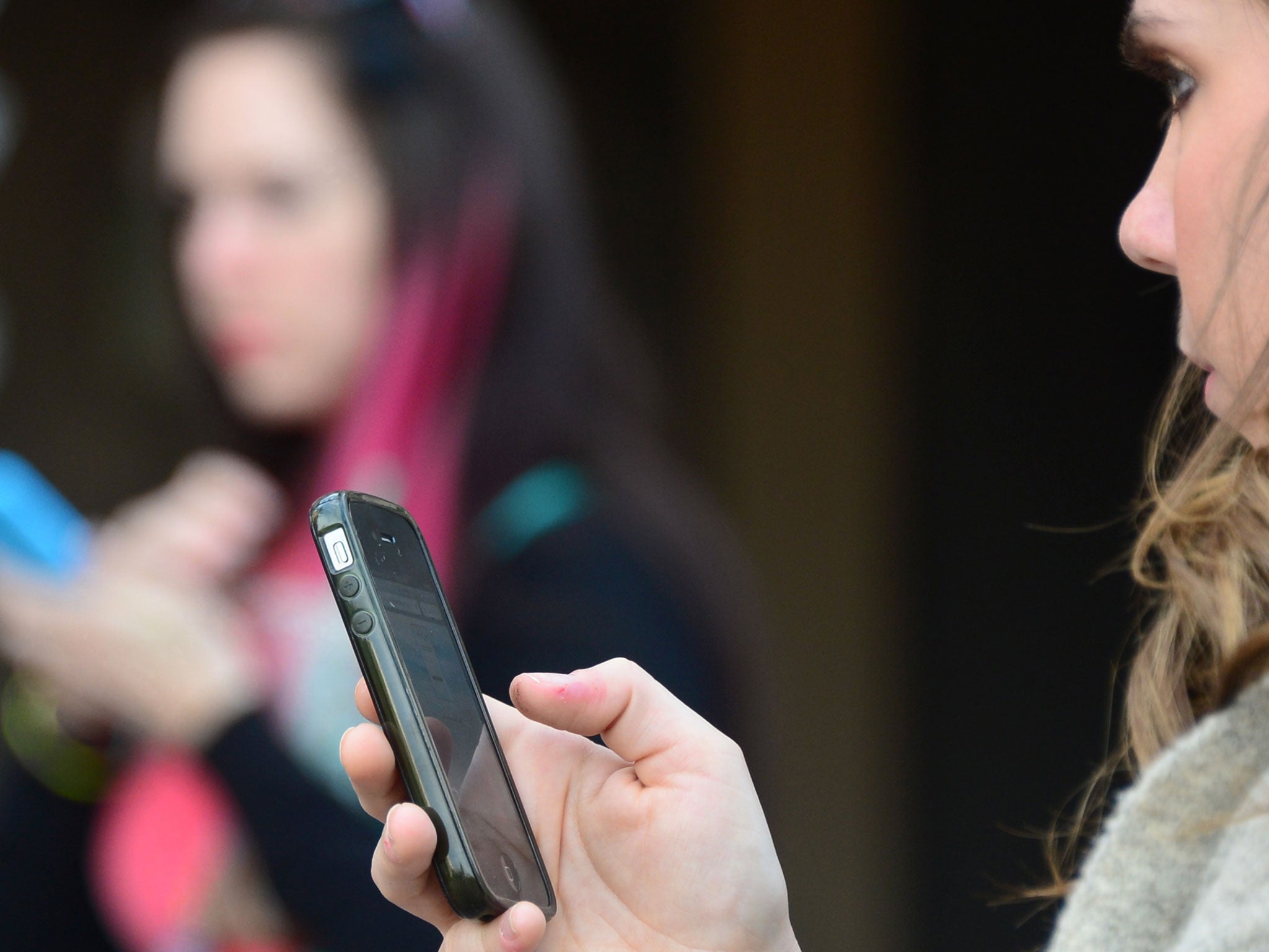 Women use their cellphones in Los Angeles, California.