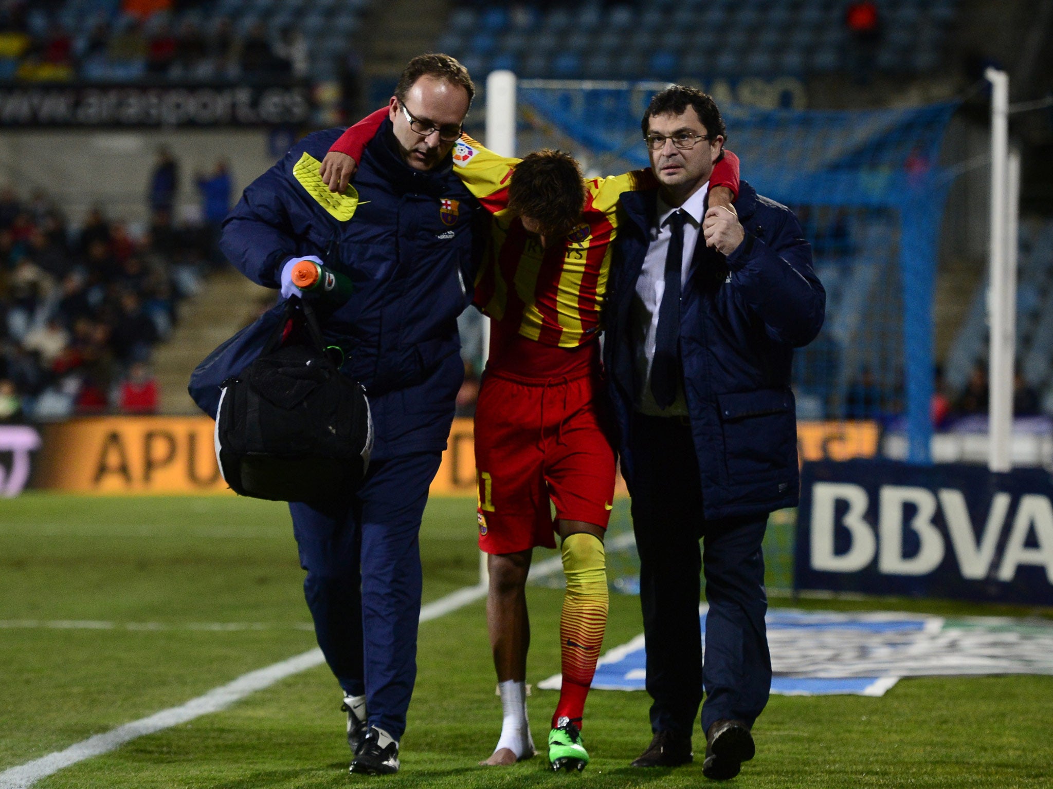 Barcelona striker Neymar is helped from the pitch