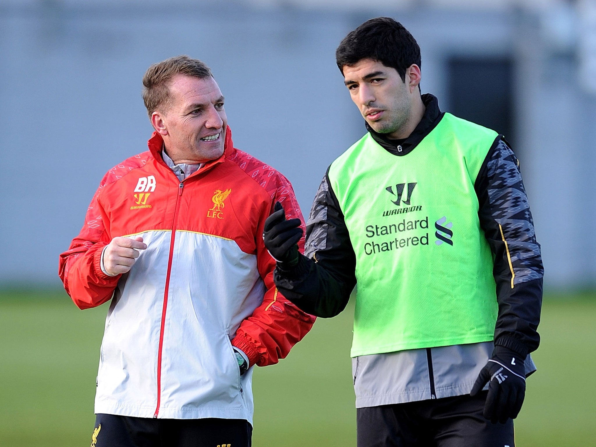 Brendan Rodgers (left) speaks to Luis Suarez during training