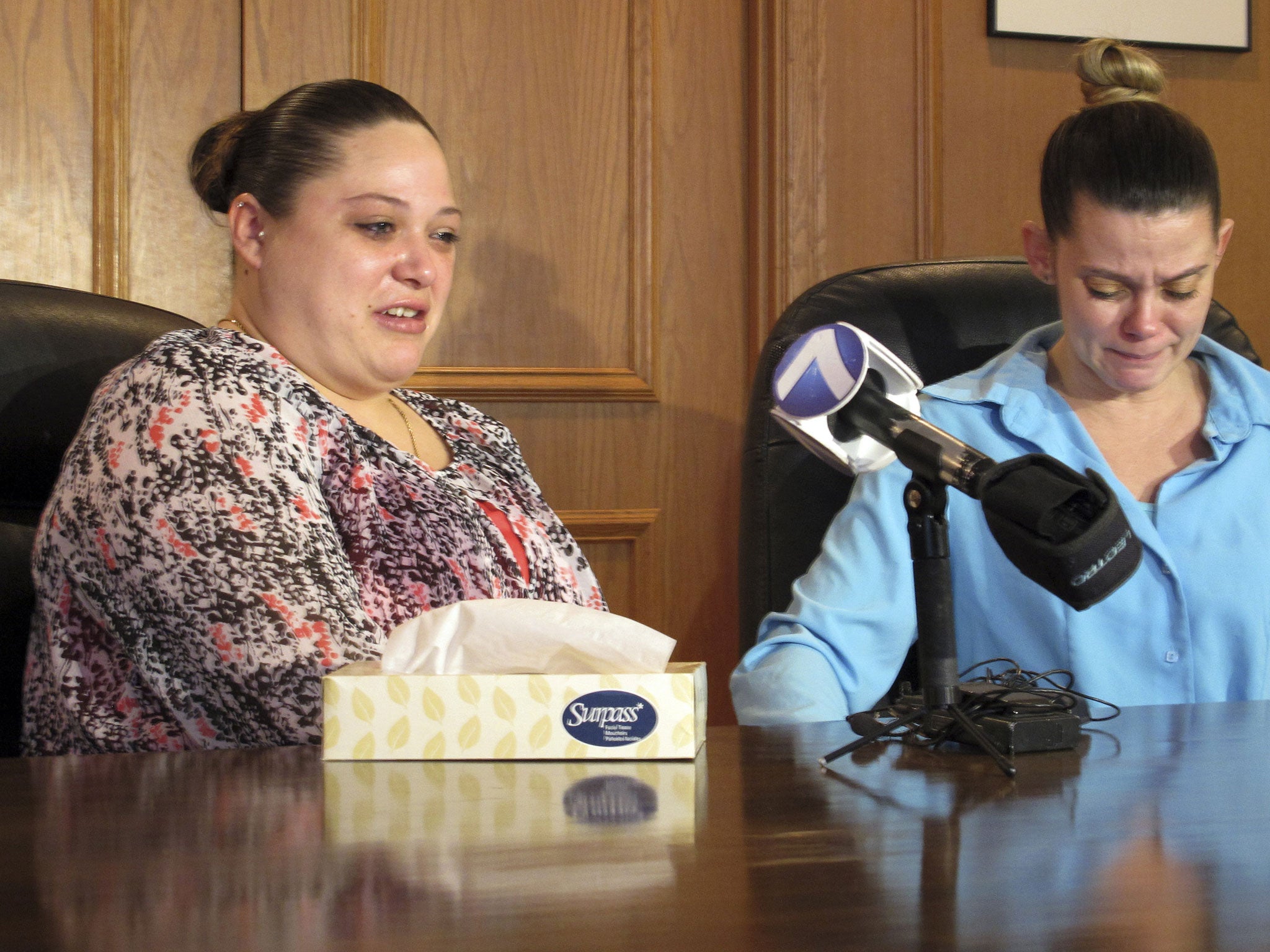 Amber McGuire, left, recounts the execution of her father, Dennis McGuire, as her sister-in-law Missie McGuire cries at a news conference Friday in Dayton, Ohio