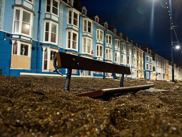 Heavy weather: Sea debris fills a street in Aberystwyth, west Wales, after ferocious storms earlier this month