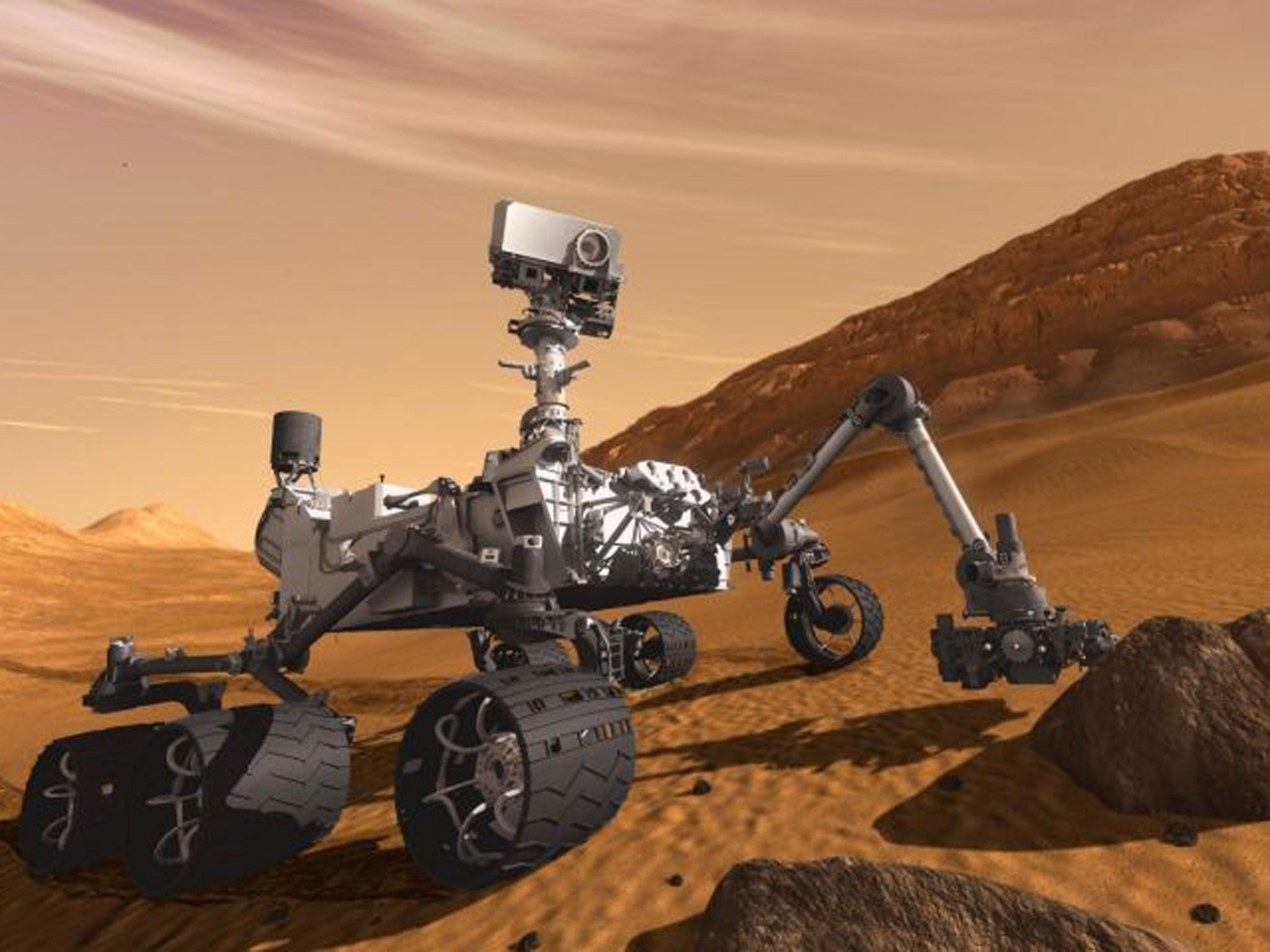 Mars Science Laboratory Curiosity rover examines a rock on Mars with a set of tools at the end of its arm, which extends about 2 meters (7 feet)