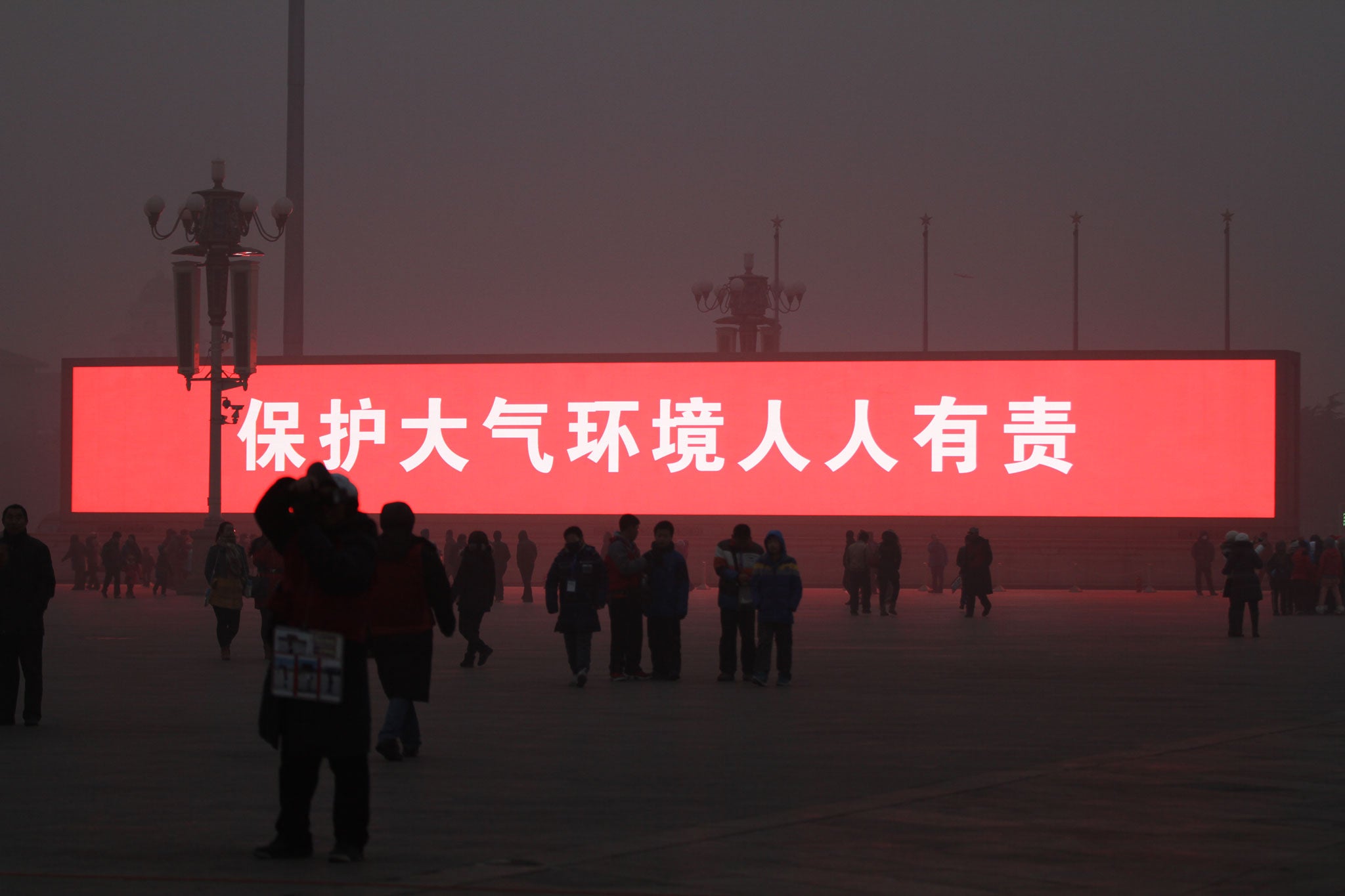 The screens were actually used to broadcast public health warnings and slogans, here reading 'protecting atmospheric environment is everyone's responsibility' (Getty)