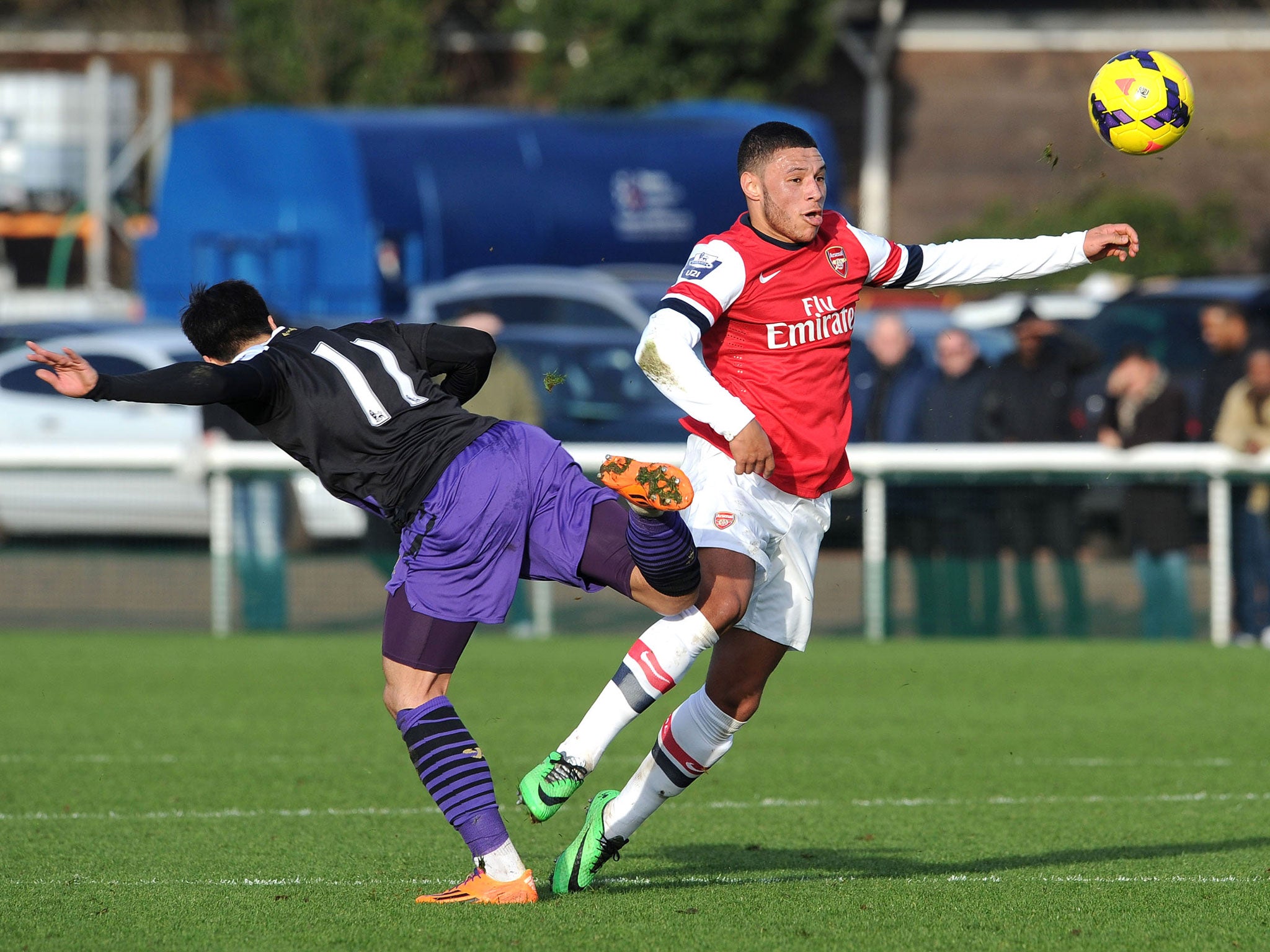 Alex Oxlade-Chamberlain competes for the ball with Liverpool's Joao Teixeiria