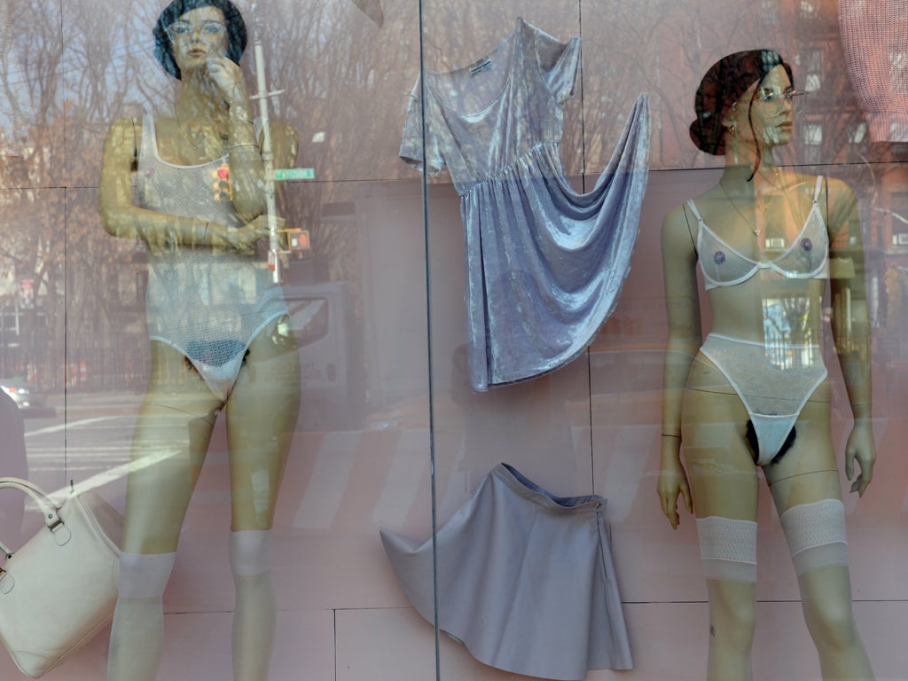 Mannequins with pubic hair are displayed in the window of an American Apparel shop on Houston Street in the Soho section of Manhattan January 17, 2014 in New York.