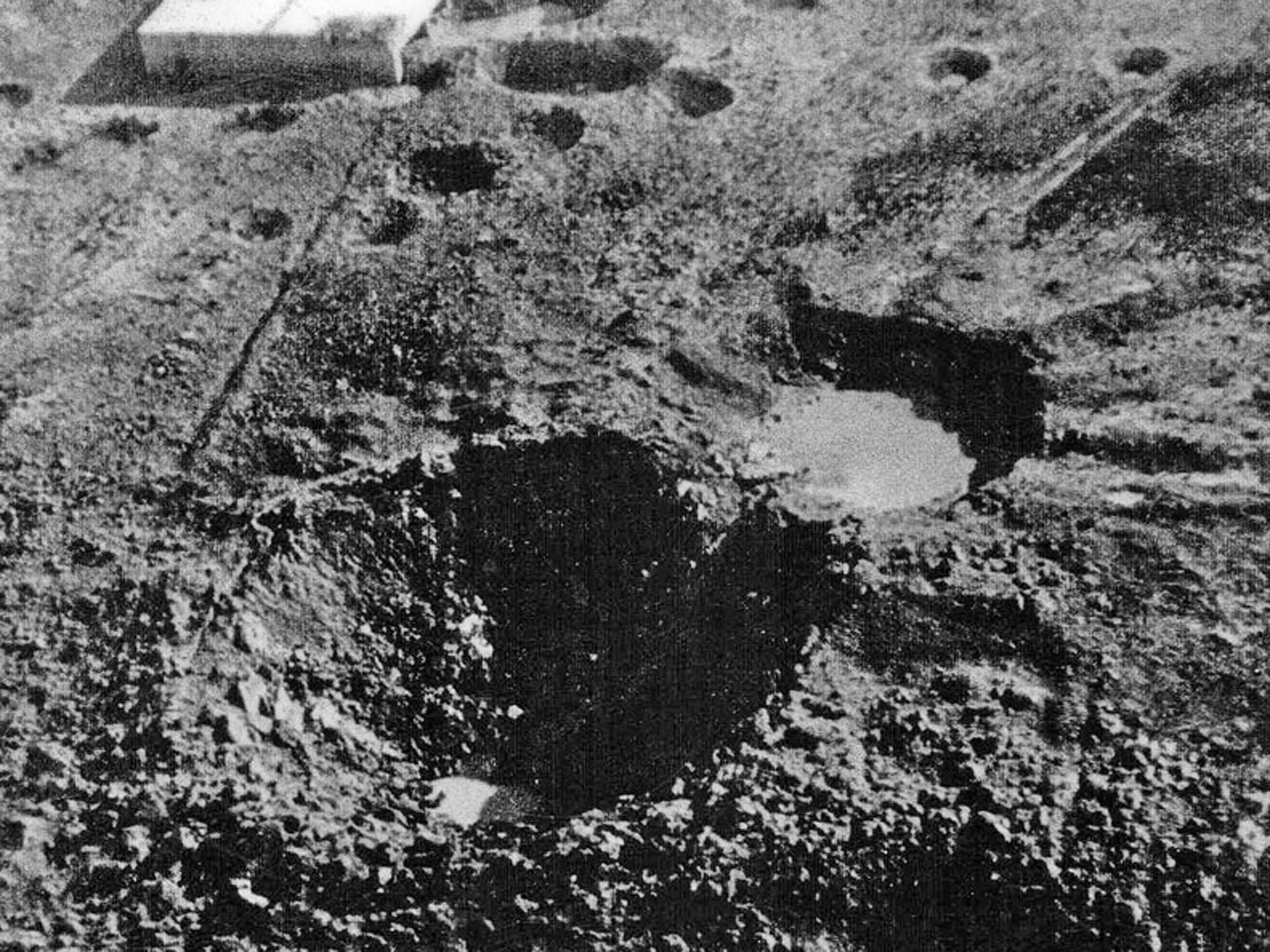 The 70 ft deep and 130 ft diameter crater which Grand Slam created in the New Forest on 13 March 1945 - with the target building in the background