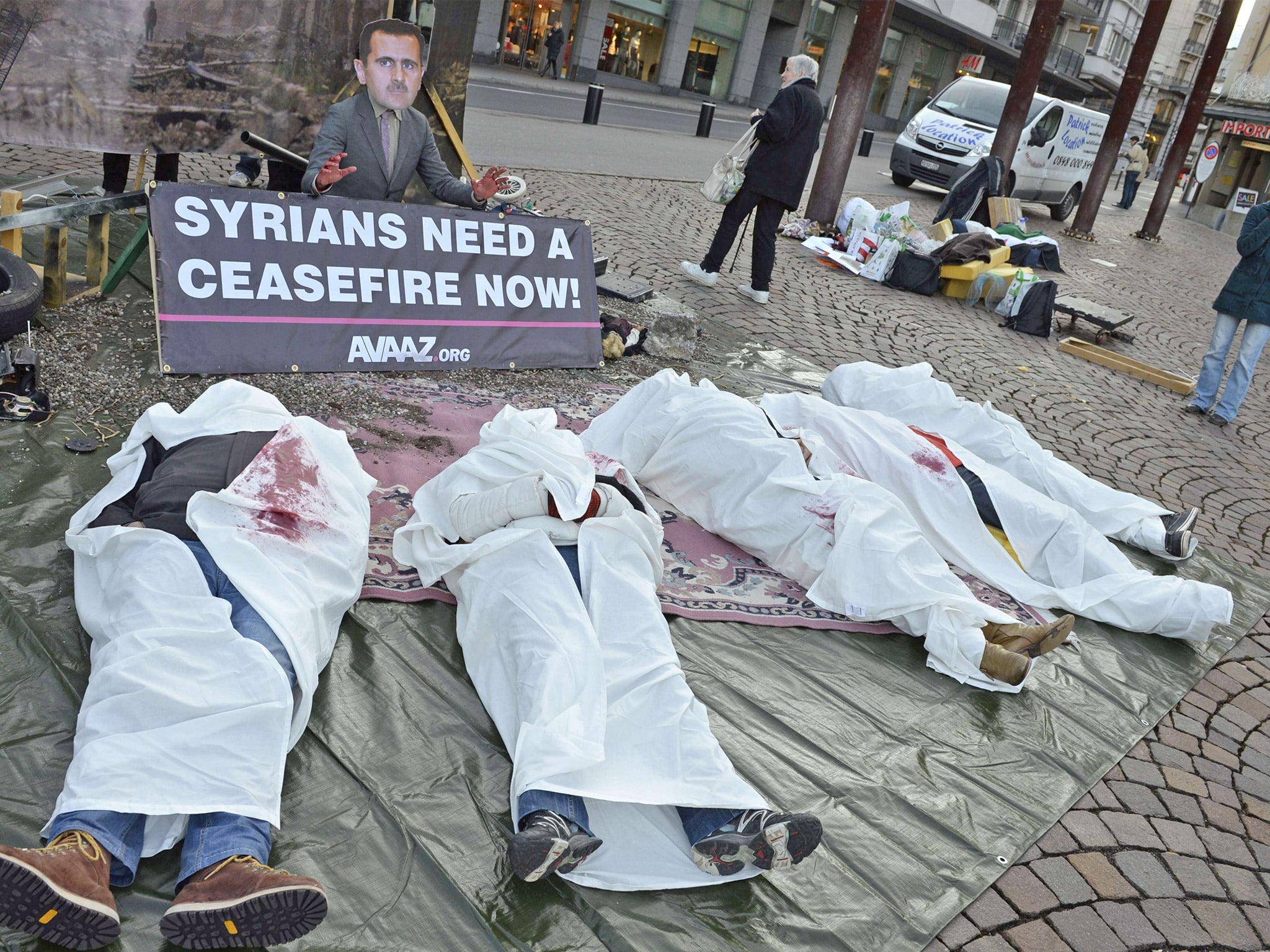 Non-profit activist website AVAAZ members take part in a street performance calling for an end to the war in Syria, in Montreux (Getty)