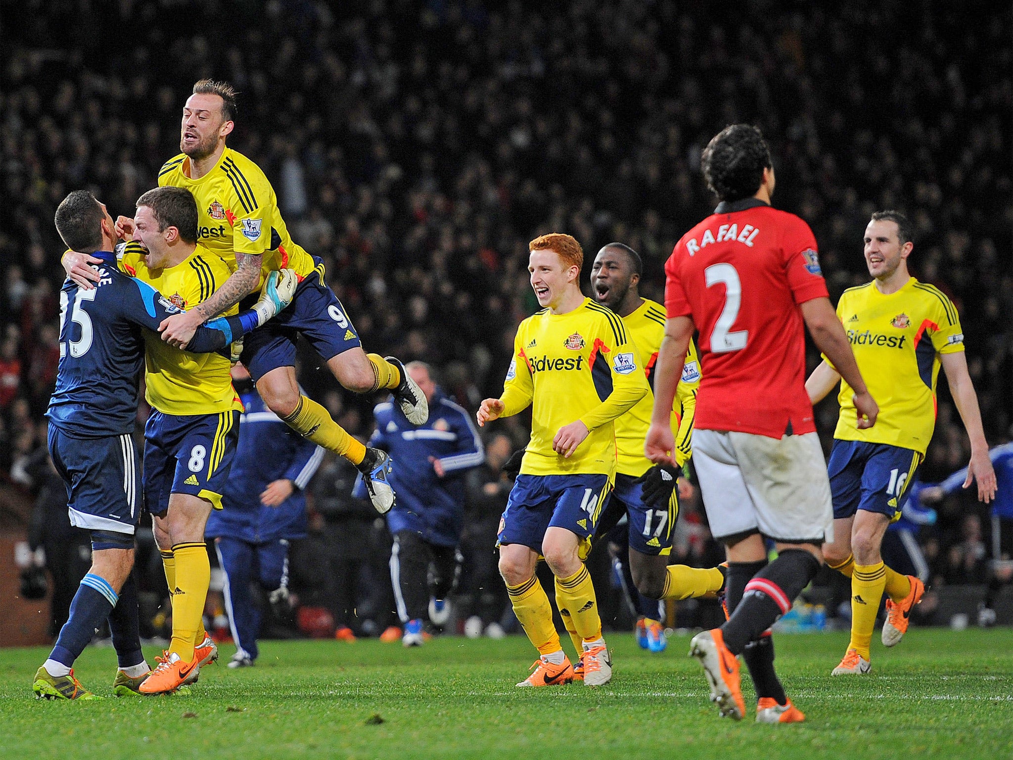 Vito Mannone is congratulated by teammates after saving Rafael Da Silva's penalty