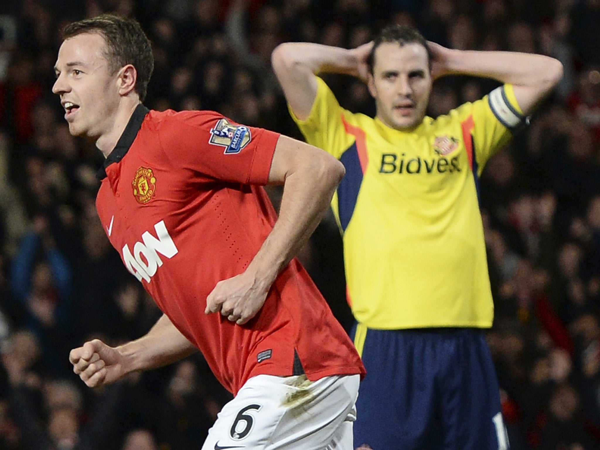 Jonny Evans celebrates his goal as John O'Shea looks on in dismay