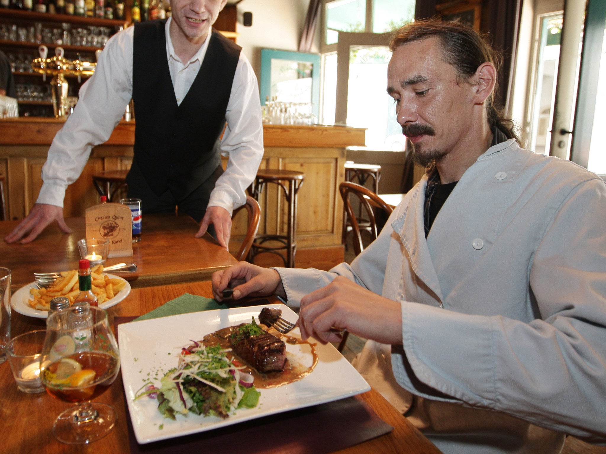 Titus Clarysse eats at a restaurant in Ghent, western Belgium in 2009; Clarysse was known in and around the university town of Ghent for walking into any restaurant of his choosing, ordering anything for steak to lobsters and walking out without paying