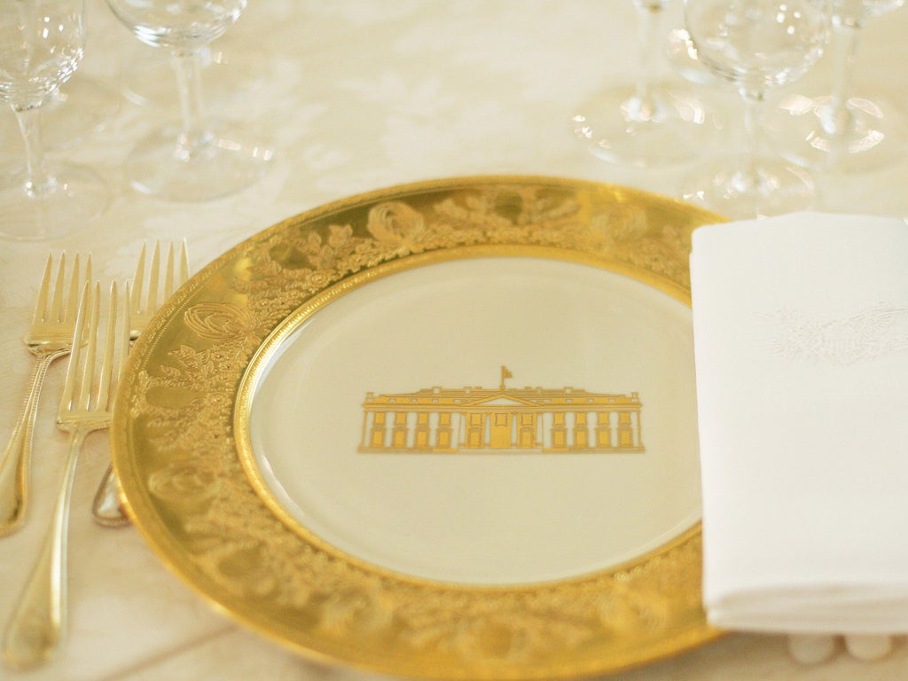 A table setting is shown during a press preview of the State dinner for Queen Elizabeth II of England and her husband Prince Philip 07 May 2006 in the State Dining Room of the White House in Washington, DC.