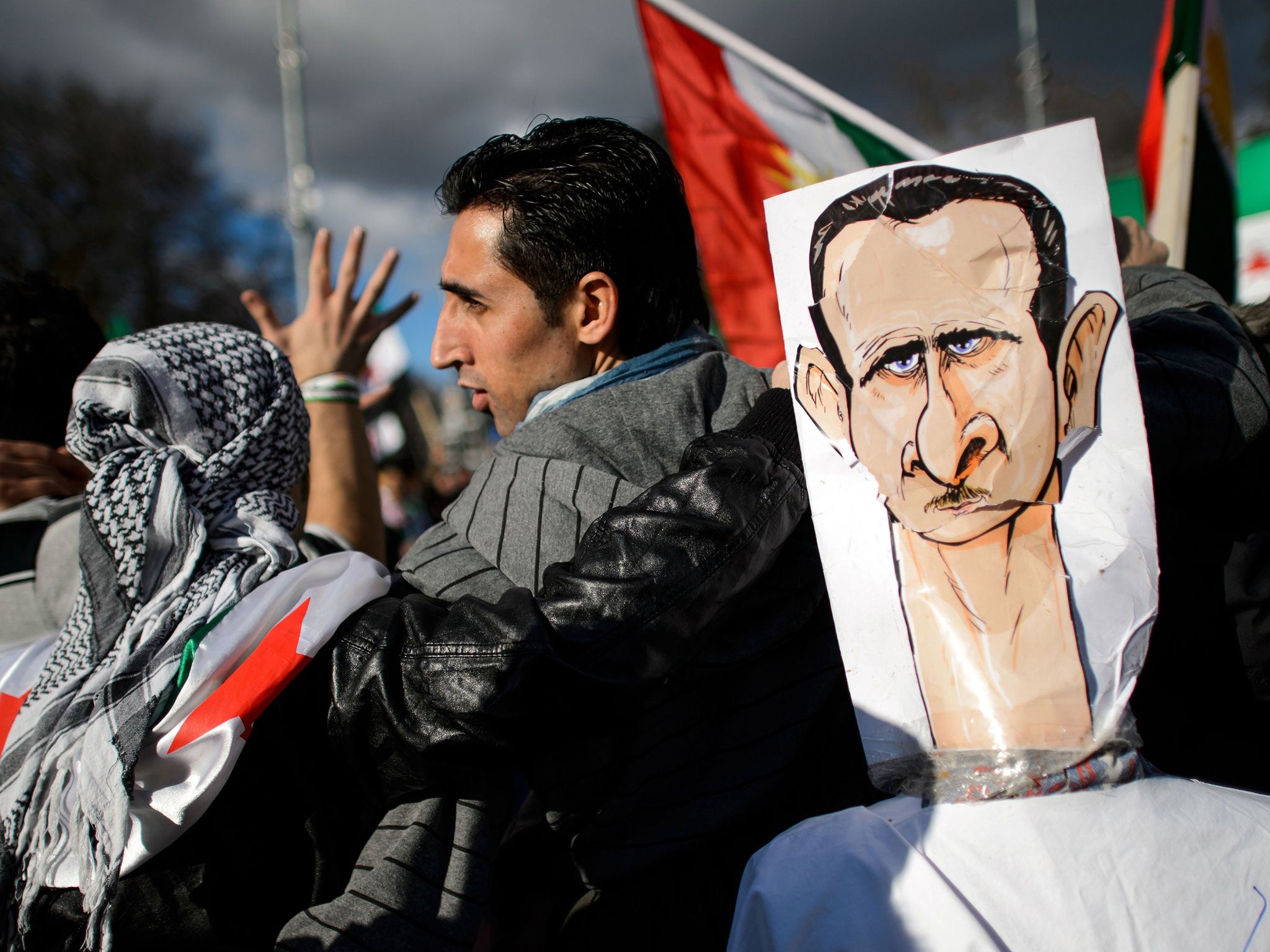 Demonstrators protest against the Syrian President Bashar al-Assad outside the UN offices in Geneva during the talks on Friday