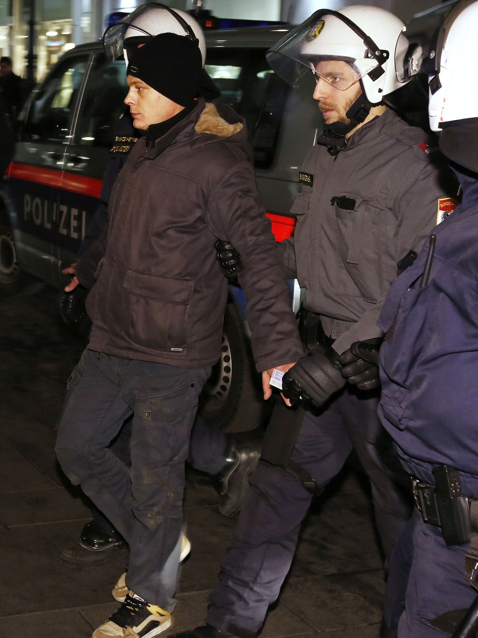 A man is arrested during a protest against the staging of an annual ball hosted by an Austrian extreme right party in the centre of Vienna on January 24, 2014