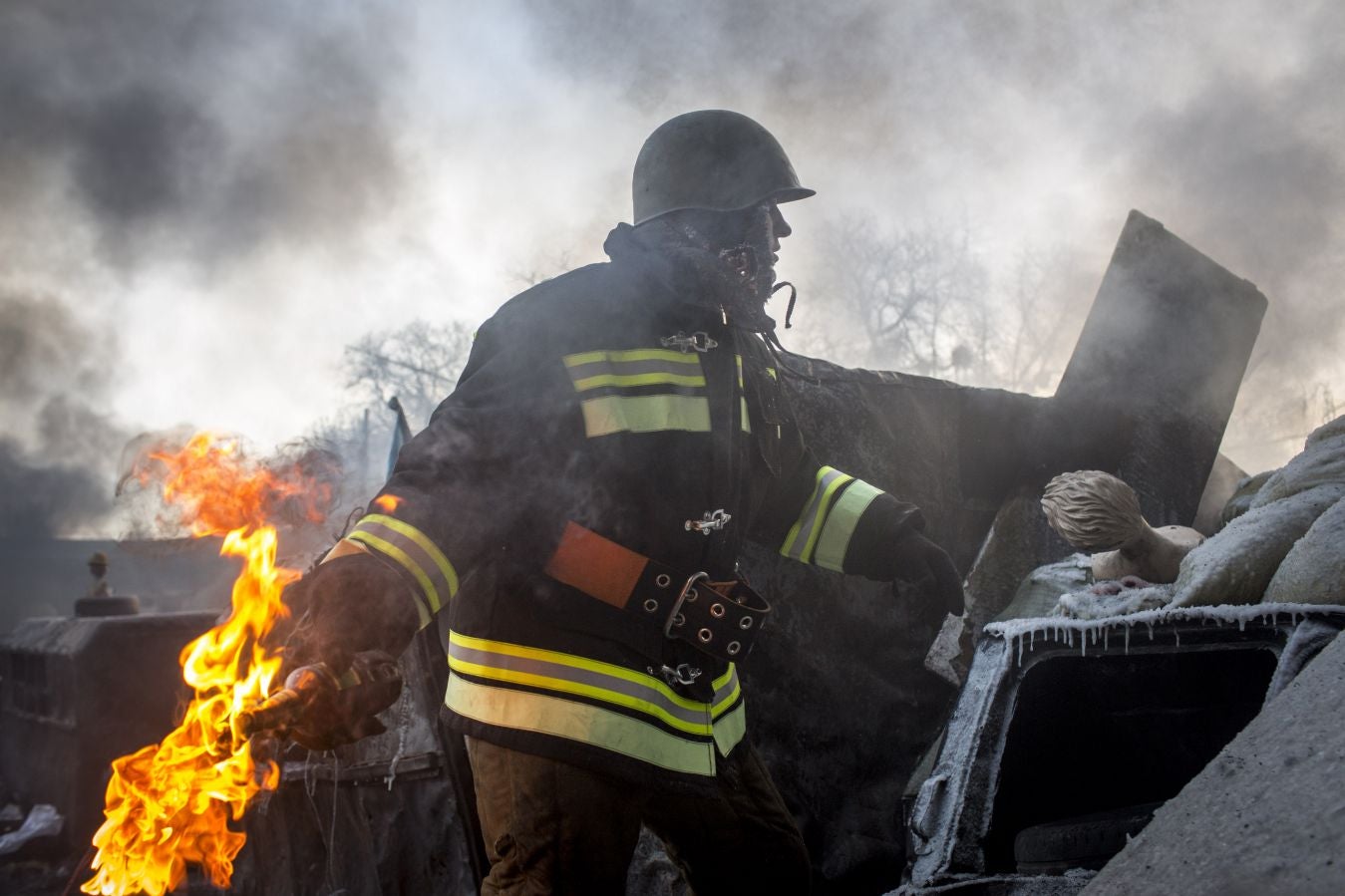 An anti-government protestor prepares to throw a molotov cocktail towards police lines near Dynamo Stadium on 25 January 2014 in Kiev