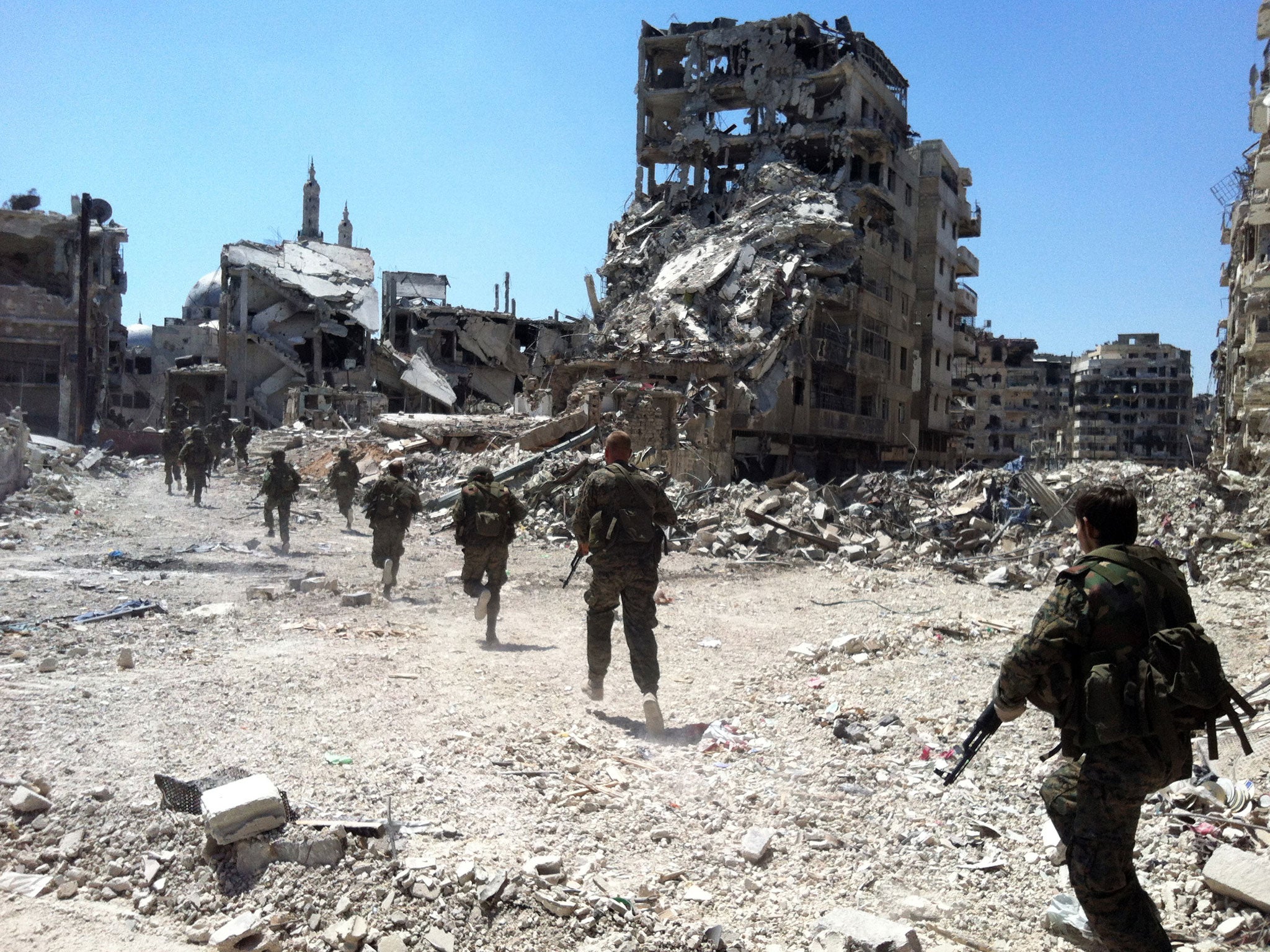 Syrian government forces patrol in the Khalidiyah neighbourhood of the central city of Homs; the city had a population of more than one million before the start of the conflict (AFP/Getty)