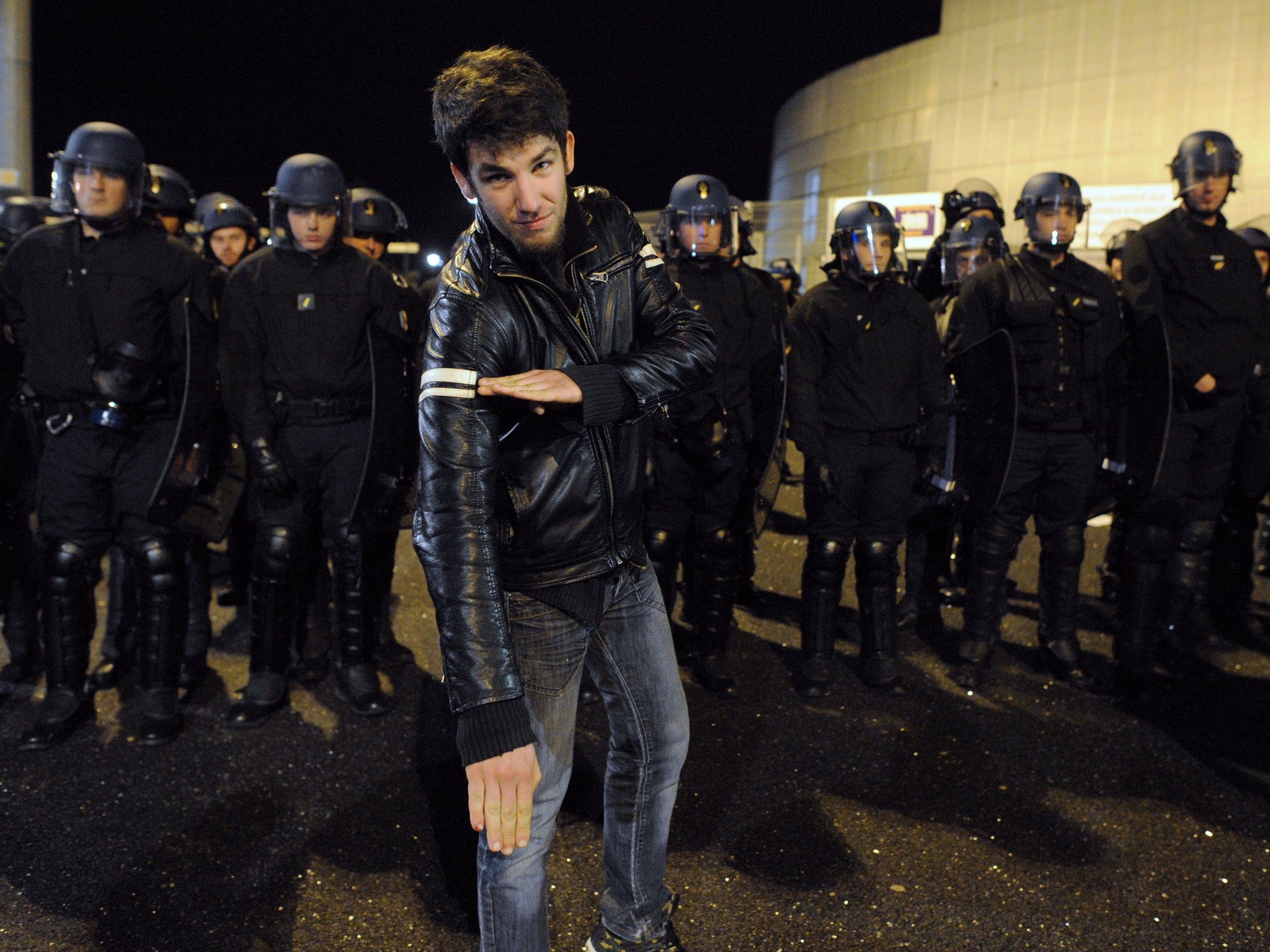 A pro-Dieudonné supporter does the 'quenelle' gesture, which is said to be a bastardised version of a Nazi salute