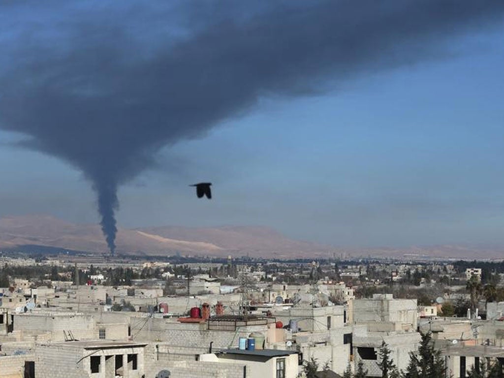 Smoke rises from a fire in Adra, east of Damascus in December 2013 (Reuters)