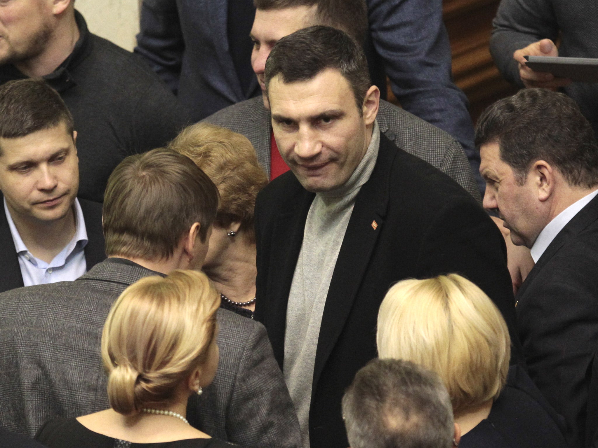 Ukrainian opposition leader Vitali Klitschko, center, talks to lawmakers in the parliament session hall, in Kiev