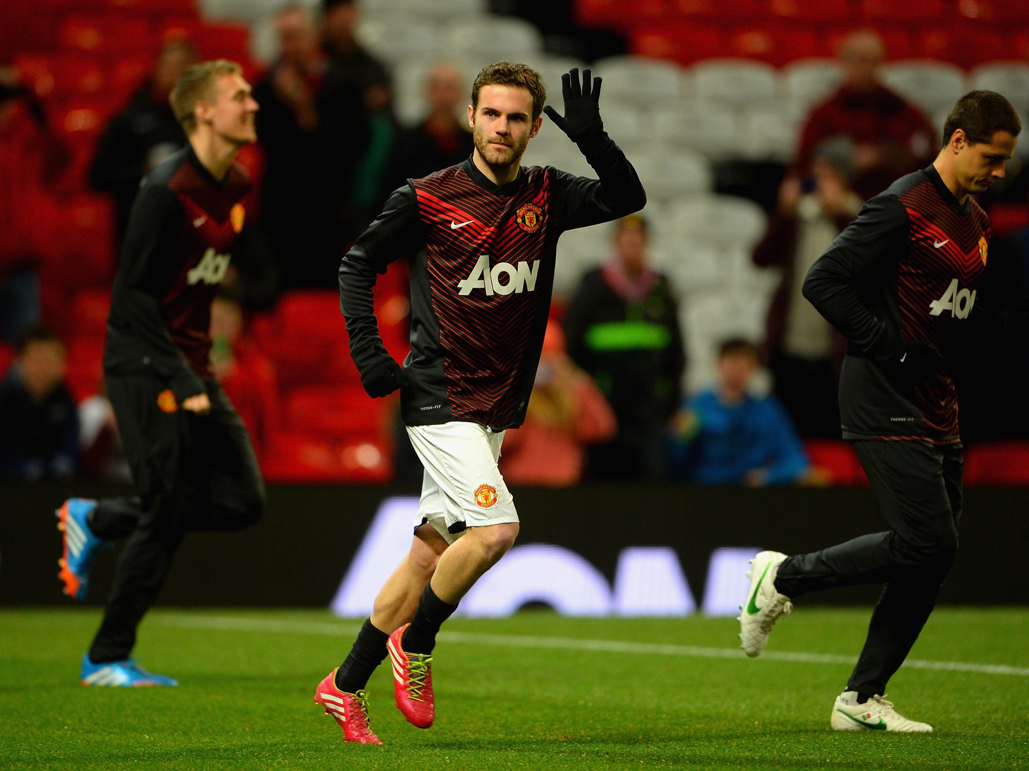 Juan Mata warms up at Old Trafford before making his debut