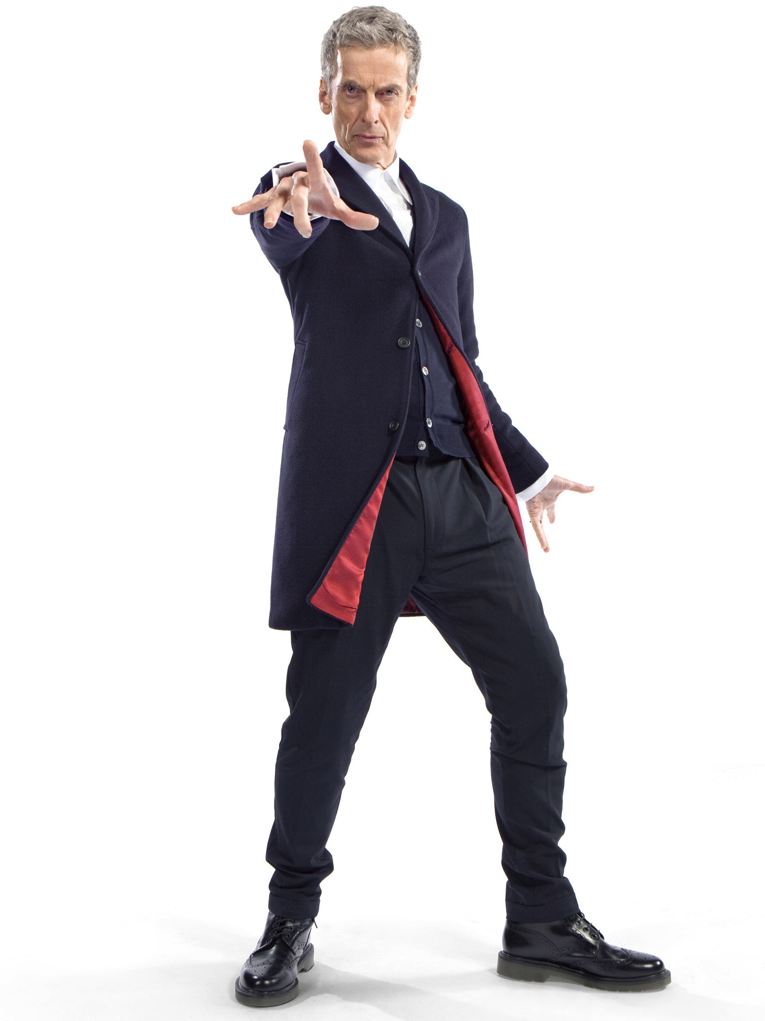 Peter Capaldi as The Doctor in a dark blue Crombie coat with red lining