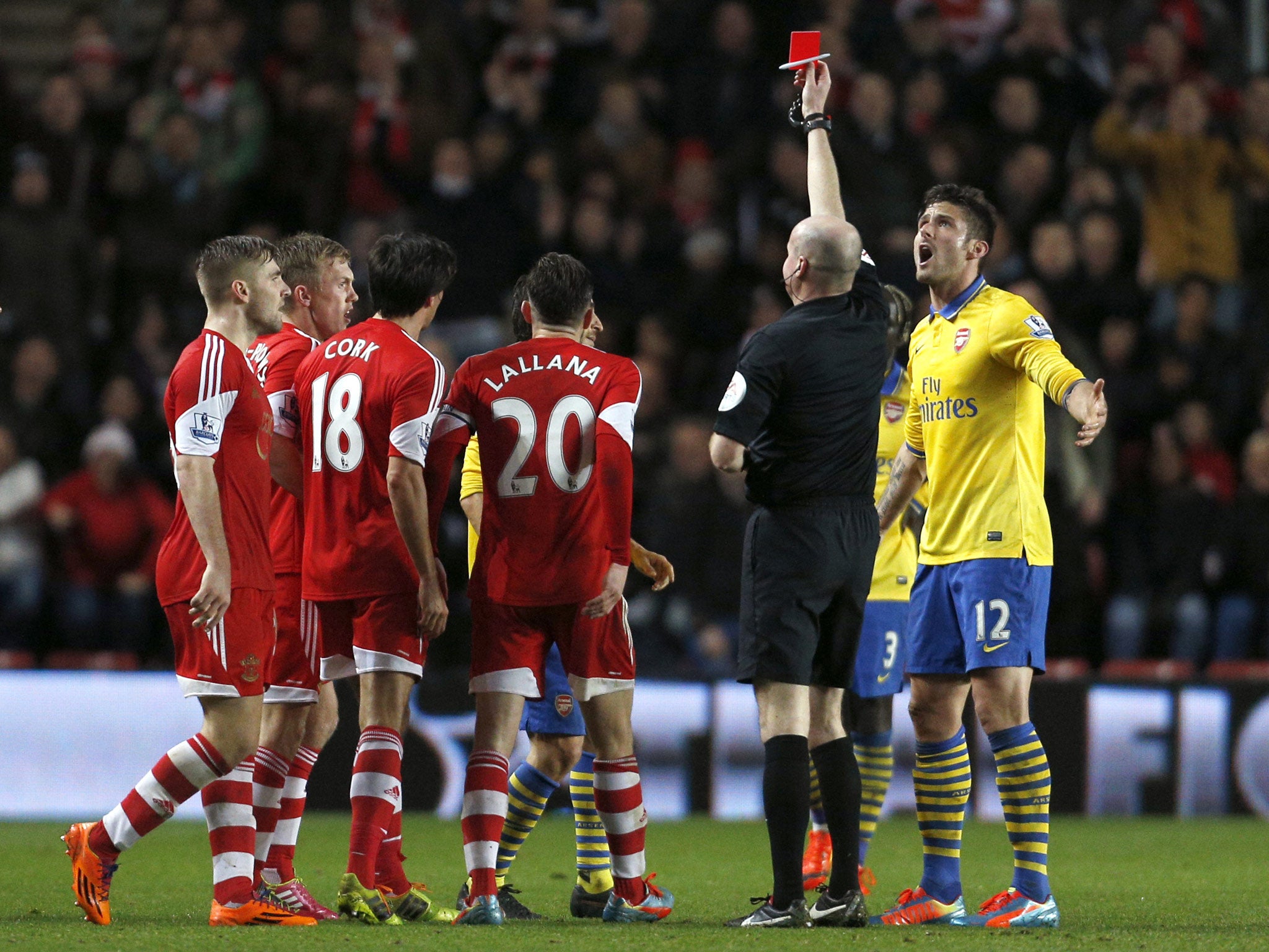 Referee Lee Mason shows the red card to Arsenal's French midfielder Mathieu Flamini