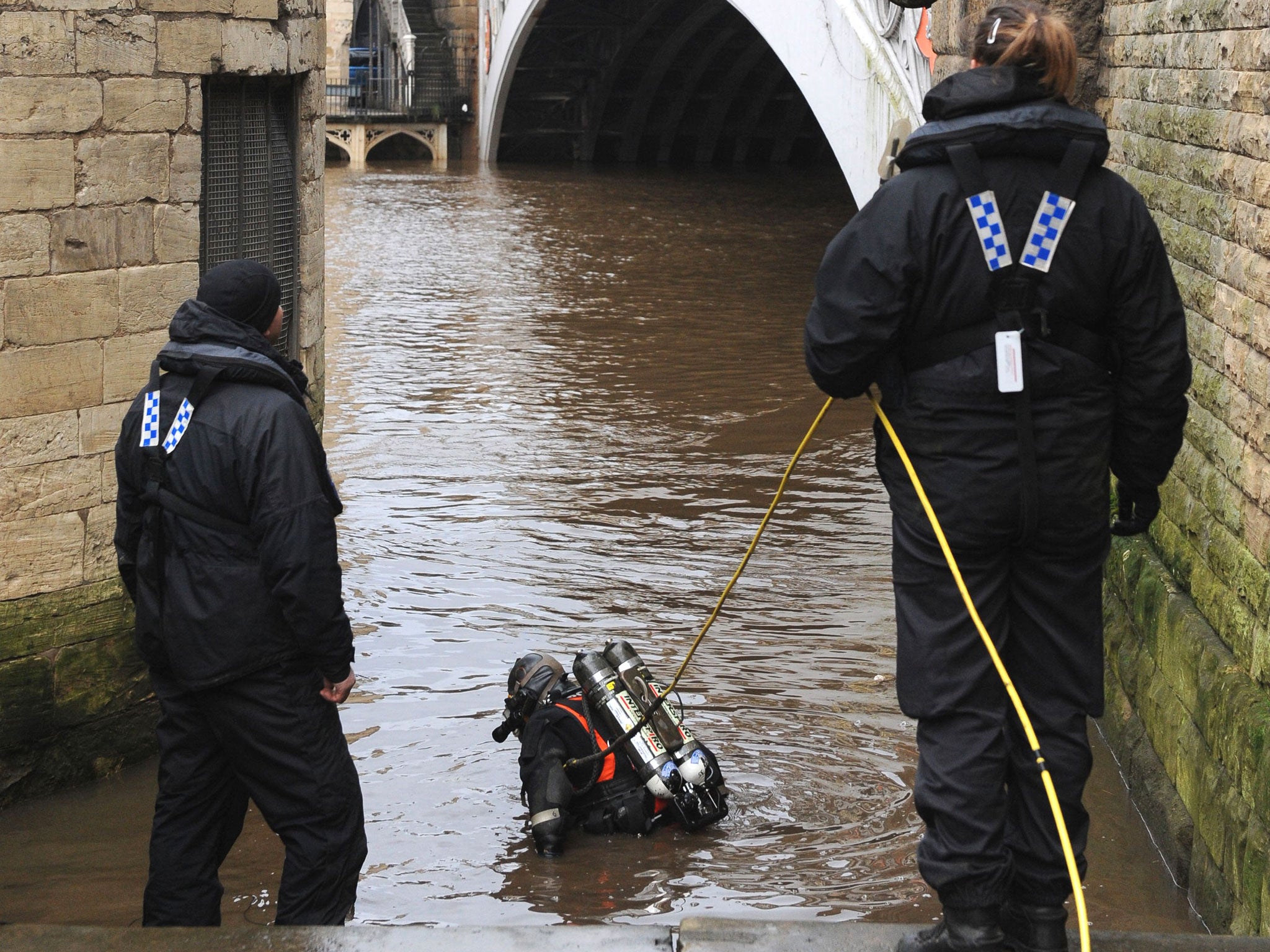 A police diver enters the River Ouse near Lendal Bridge in York in the search for missing student Megan Robert