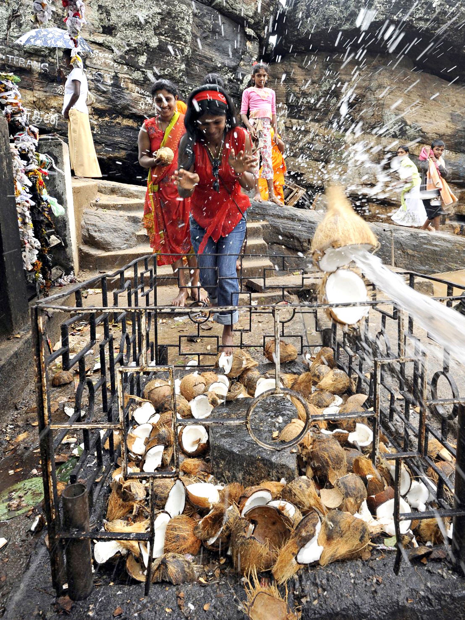 Shell out: a devotee smashes a coconut at the Koneswaram temple