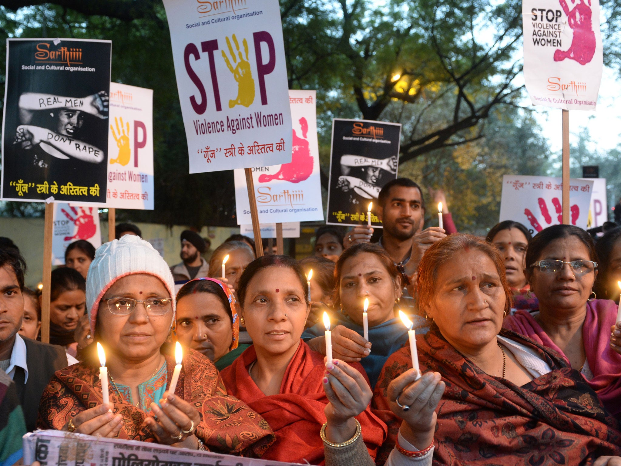 Indian demonstrators hold candles in honour of a physiotherapy student who was gang-raped and murdered