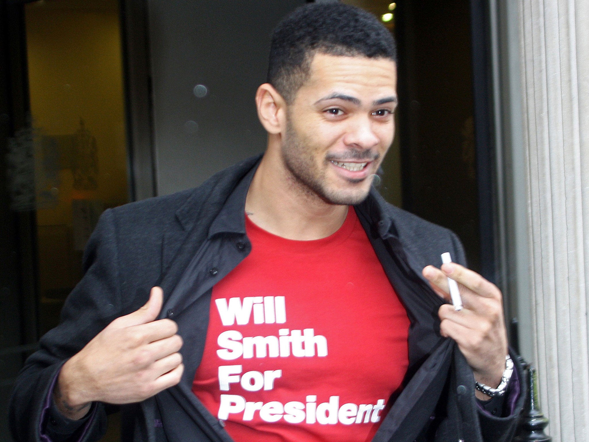 Robert Morris shows his t-shirt as he leaves Bristol Crown Court, having been cleared of kidnap and robbery by a jury