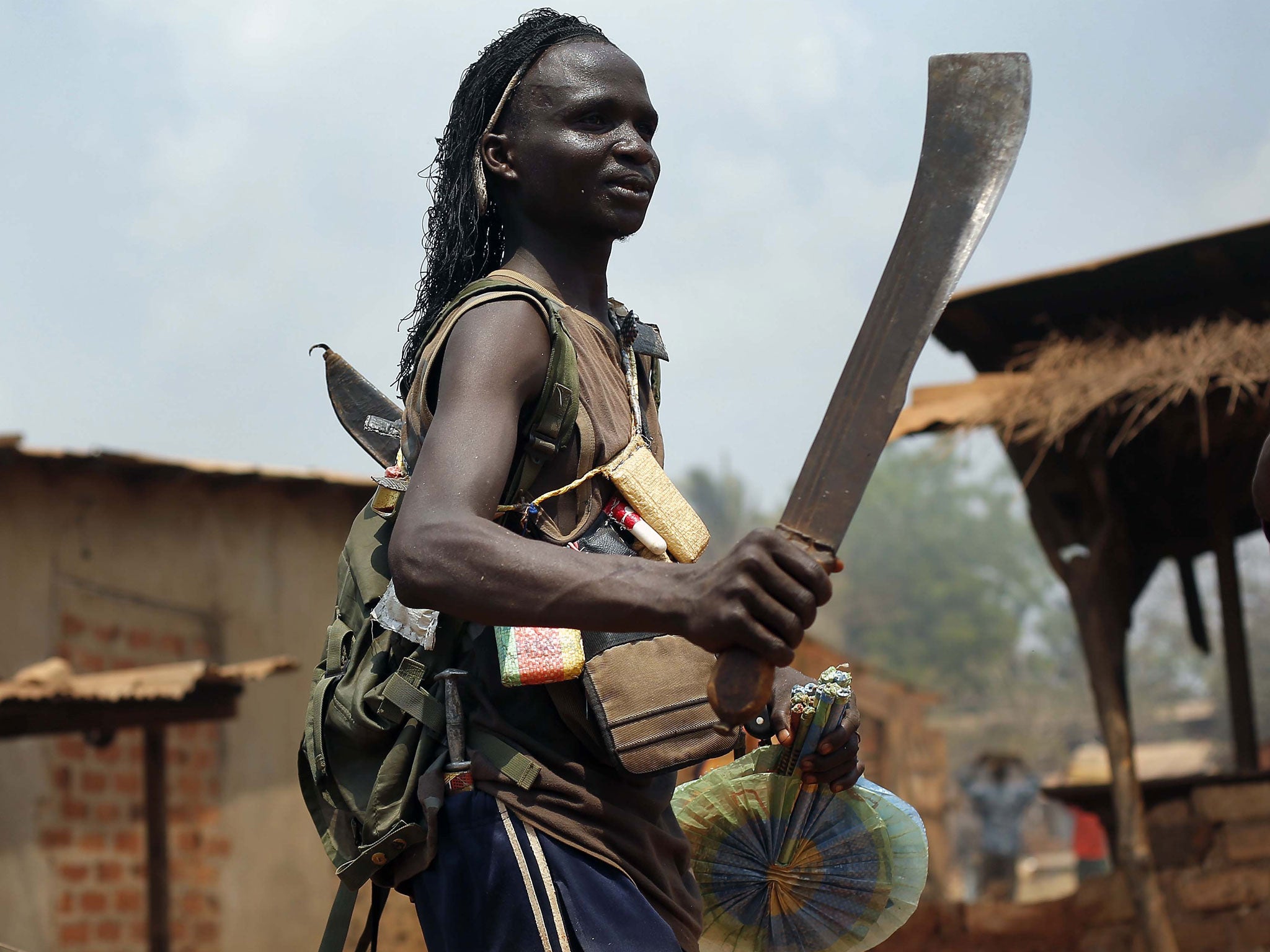 A Christian anti-balaka youth loots a market with friends, in the PK13 district of Bangui last week following the departure of the Séléka alliance from the Muslim neighbourhood