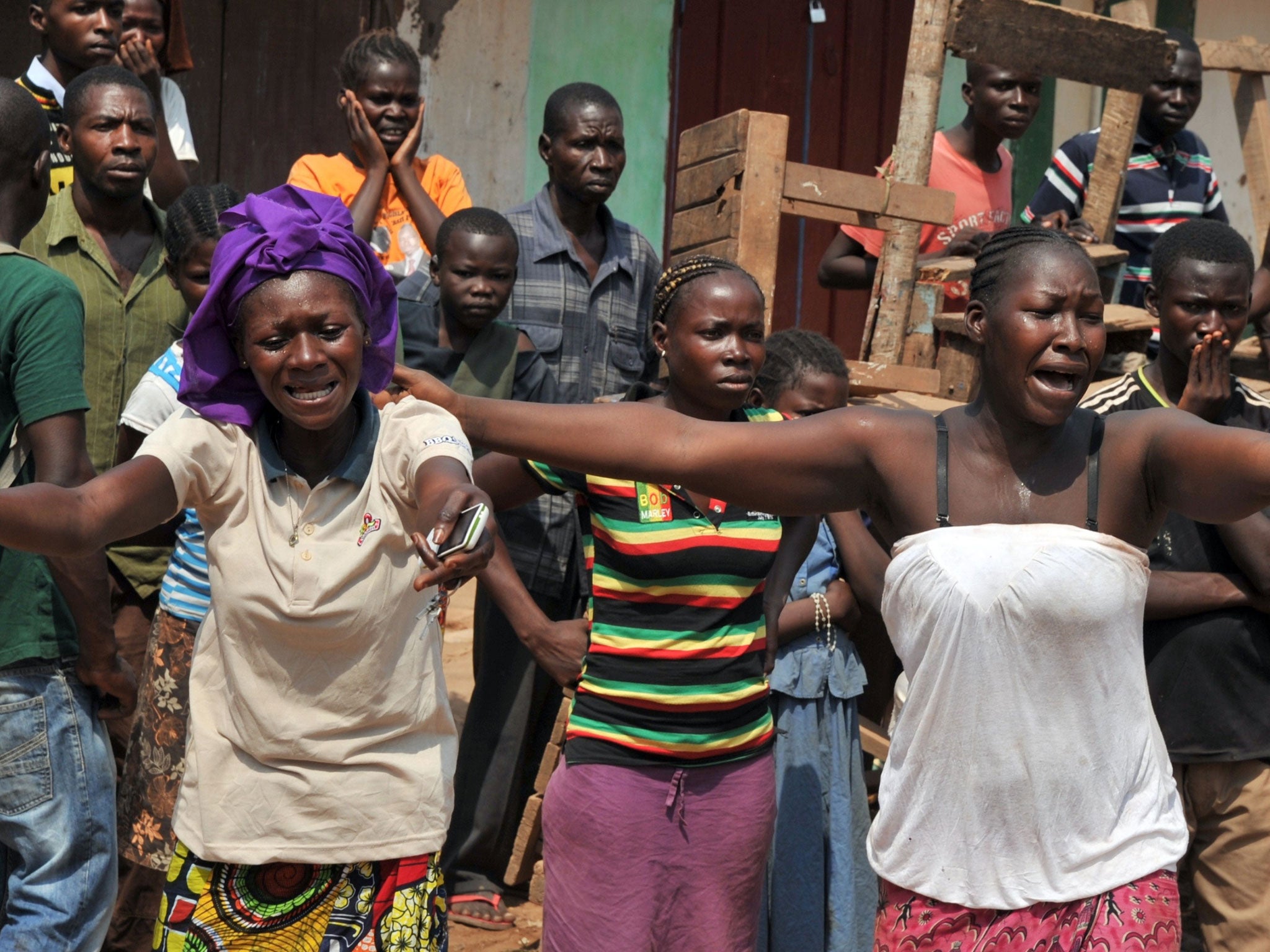 The wife (right) and sister of a Christian mistakenly killed by anti-balaka fighters react as his body is transported in Bangui this week