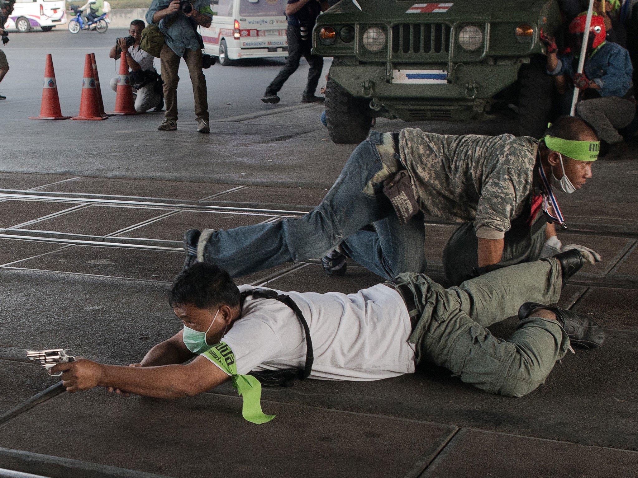 An anti-government protester aims his gun