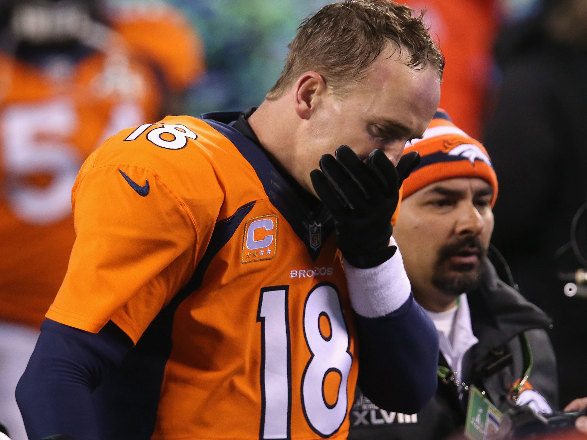 Quarterback Peyton Manning #18 of the Denver Broncos walks off the field after their 43-8 loss