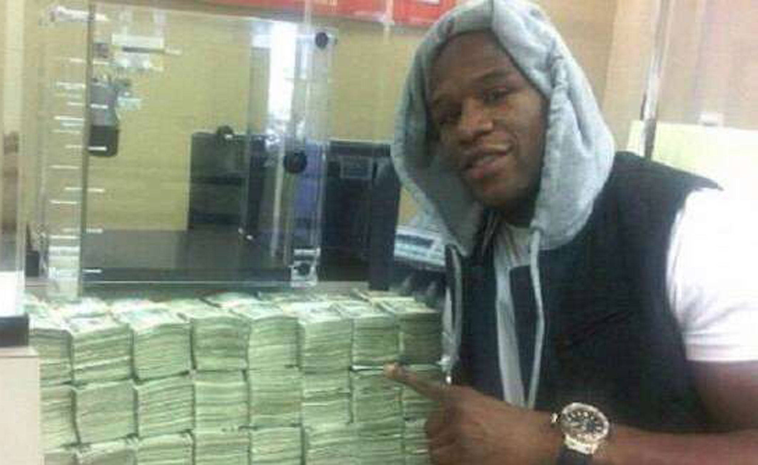 Floyd Mayweather, pictured in 2012 next to a large sum of money that triggered claims he has placed a $10.4m bet on the 2014 Super Bowl