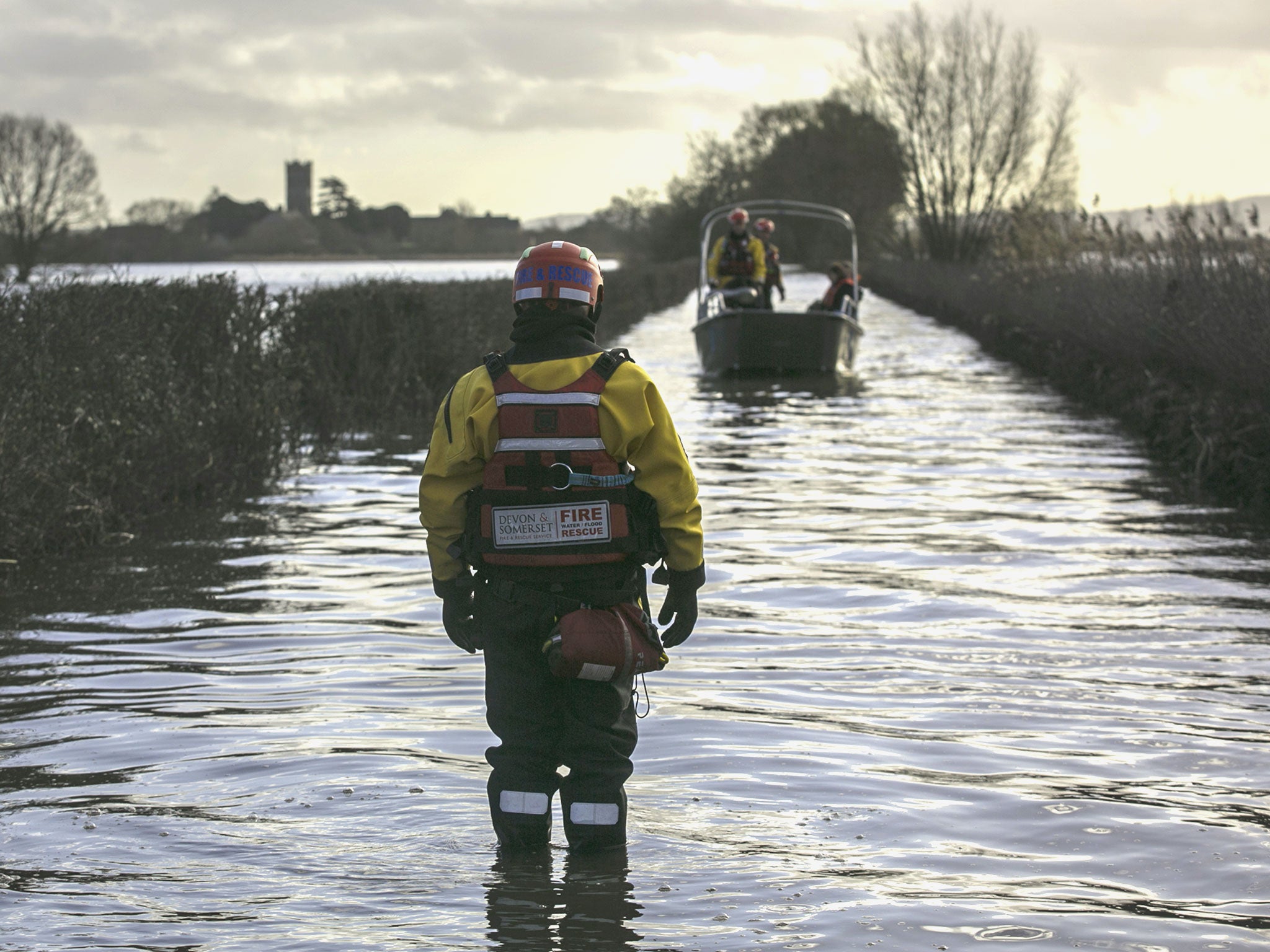 The humanitarian support boat operated by a crew from Devon and Somerset Fire and Rescue Service arrives from Muchelney, a village near Langport in Somerset still cut off by flood water