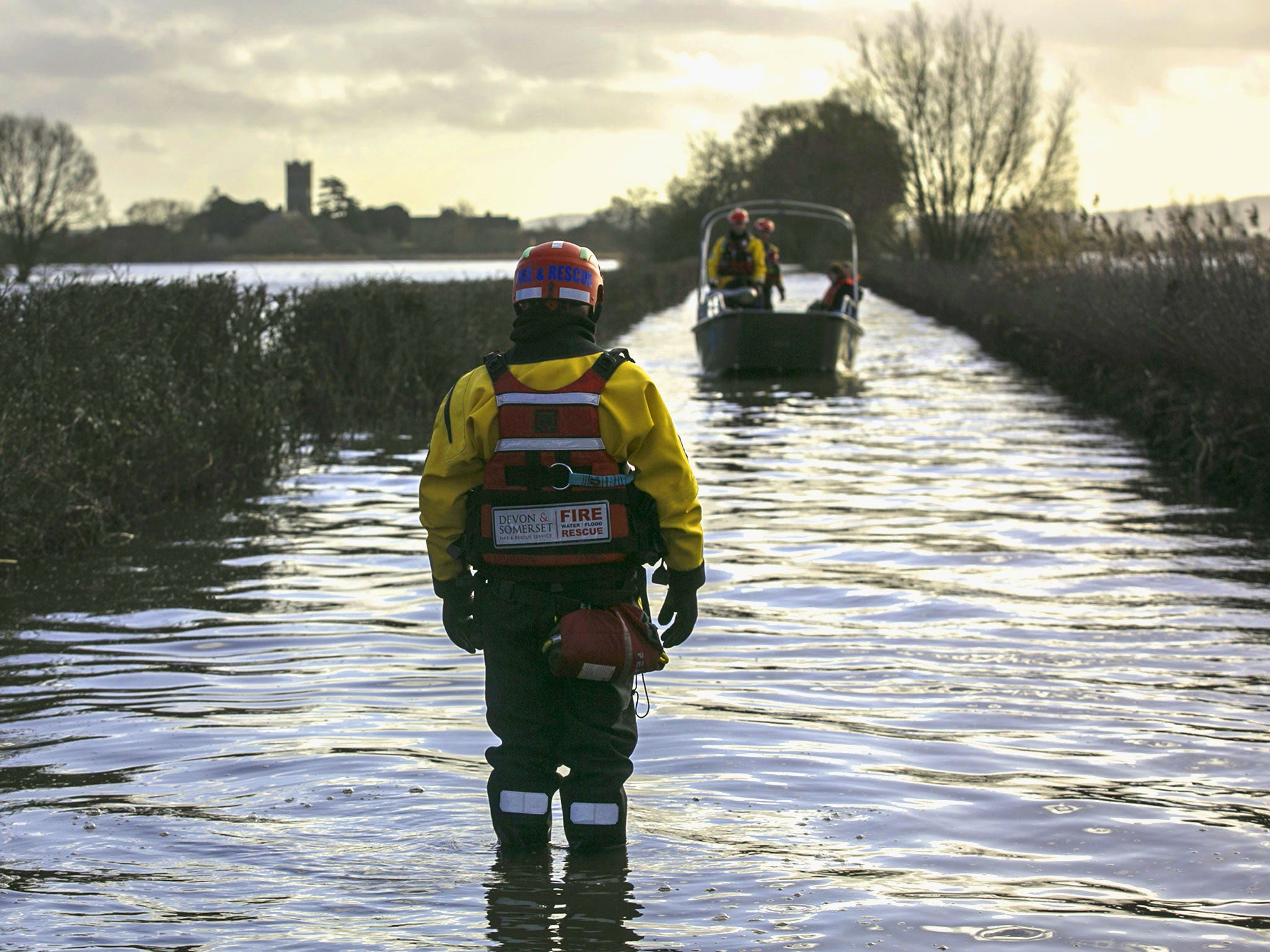 The humanitarian support boat operated by a crew from Devon and Somerset Fire and Rescue Service arrives from Muchelney, a village near Langport in Somerset still cut off by flood water